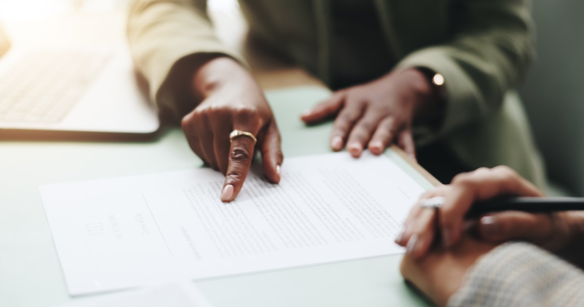 Business people, hands and pointing on contract for legal documents, application and agreement in office. Pen, closeup and person explain paperwork for policy, form or deal in workplace or company