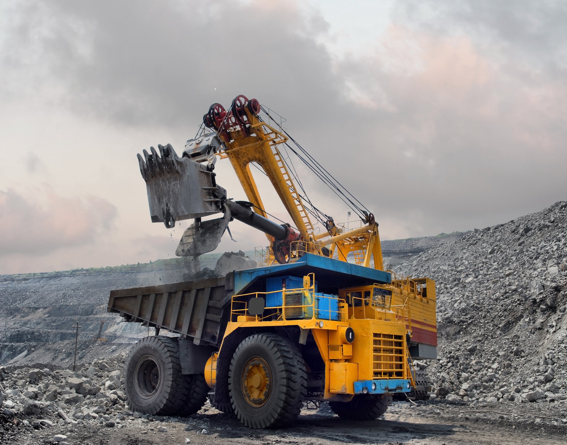 Loading of iron ore on very big dump-body truck