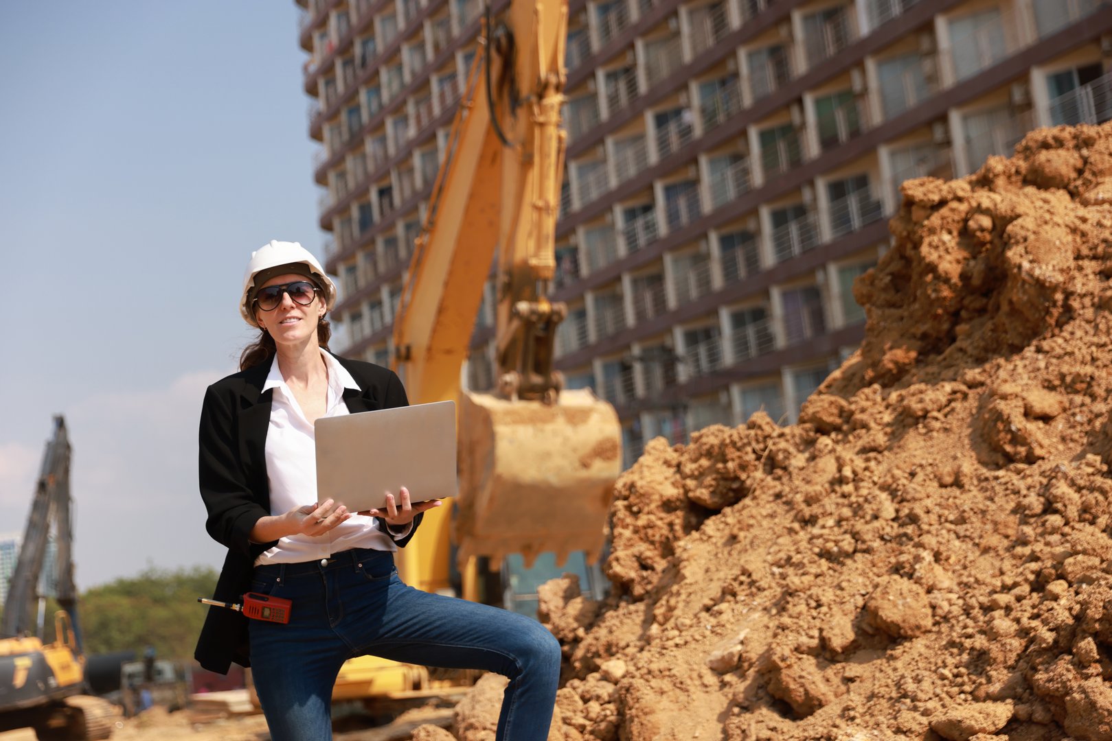 Project manager examining blueprint at construction site