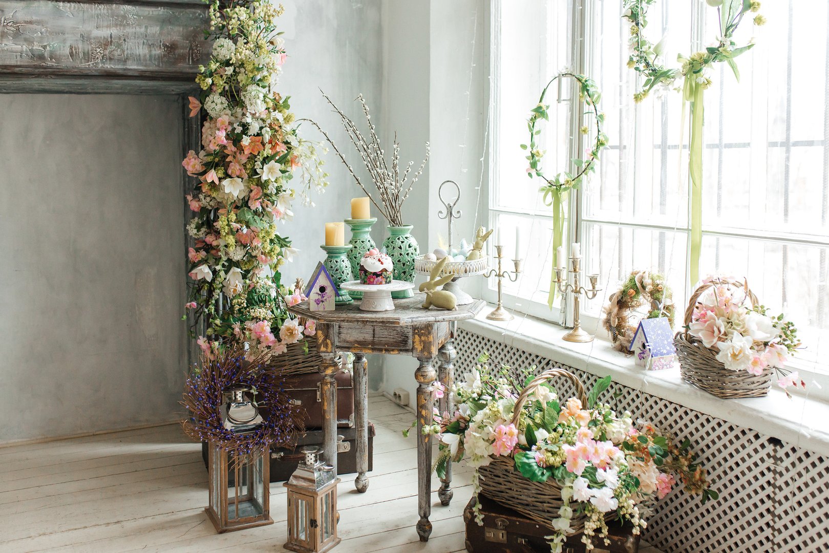 Stylish bright interior of the living room, decorated for Easter. Fireplace with flowers. There's no one in the room