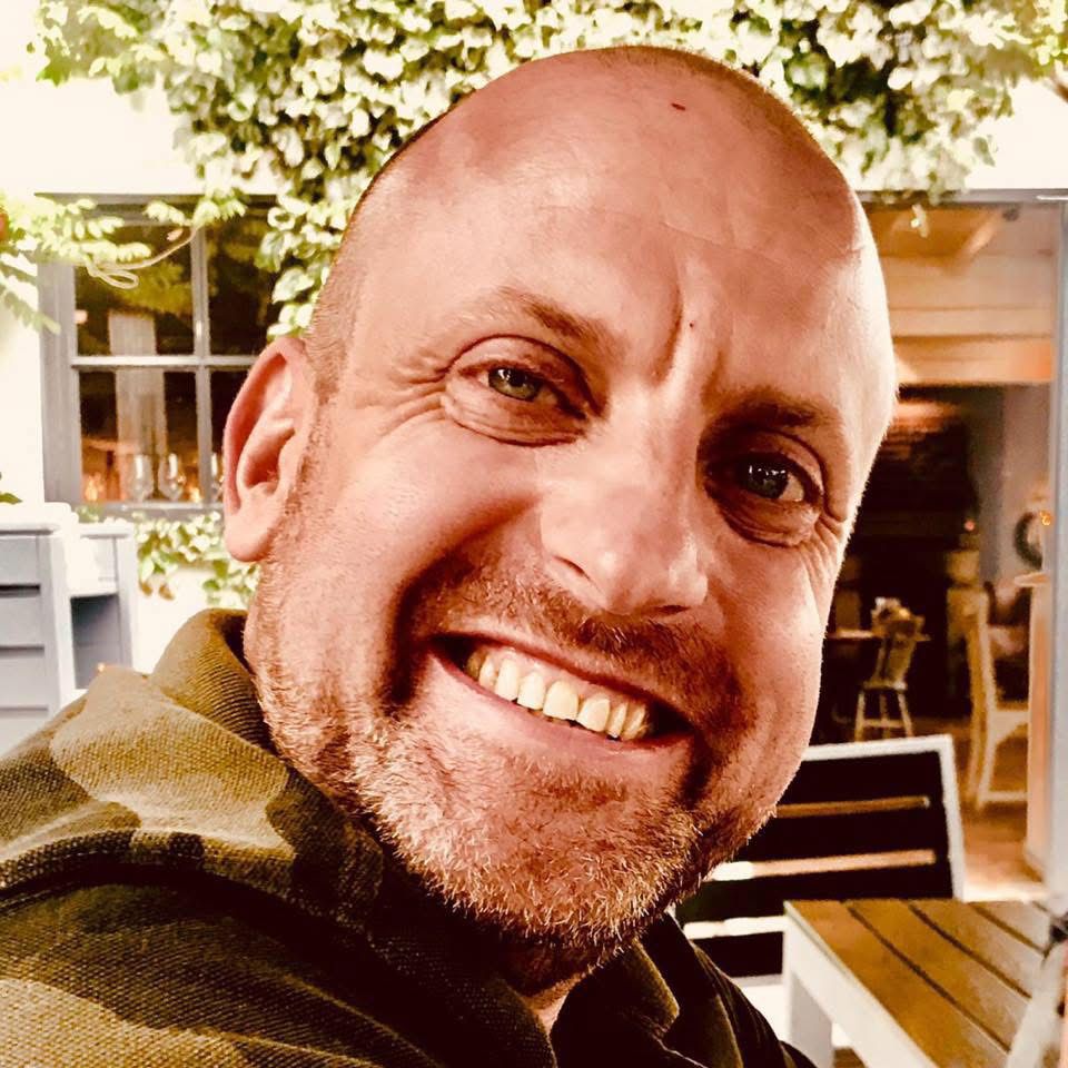 Professional headshot of Neil McCann, Customer Experience Manager