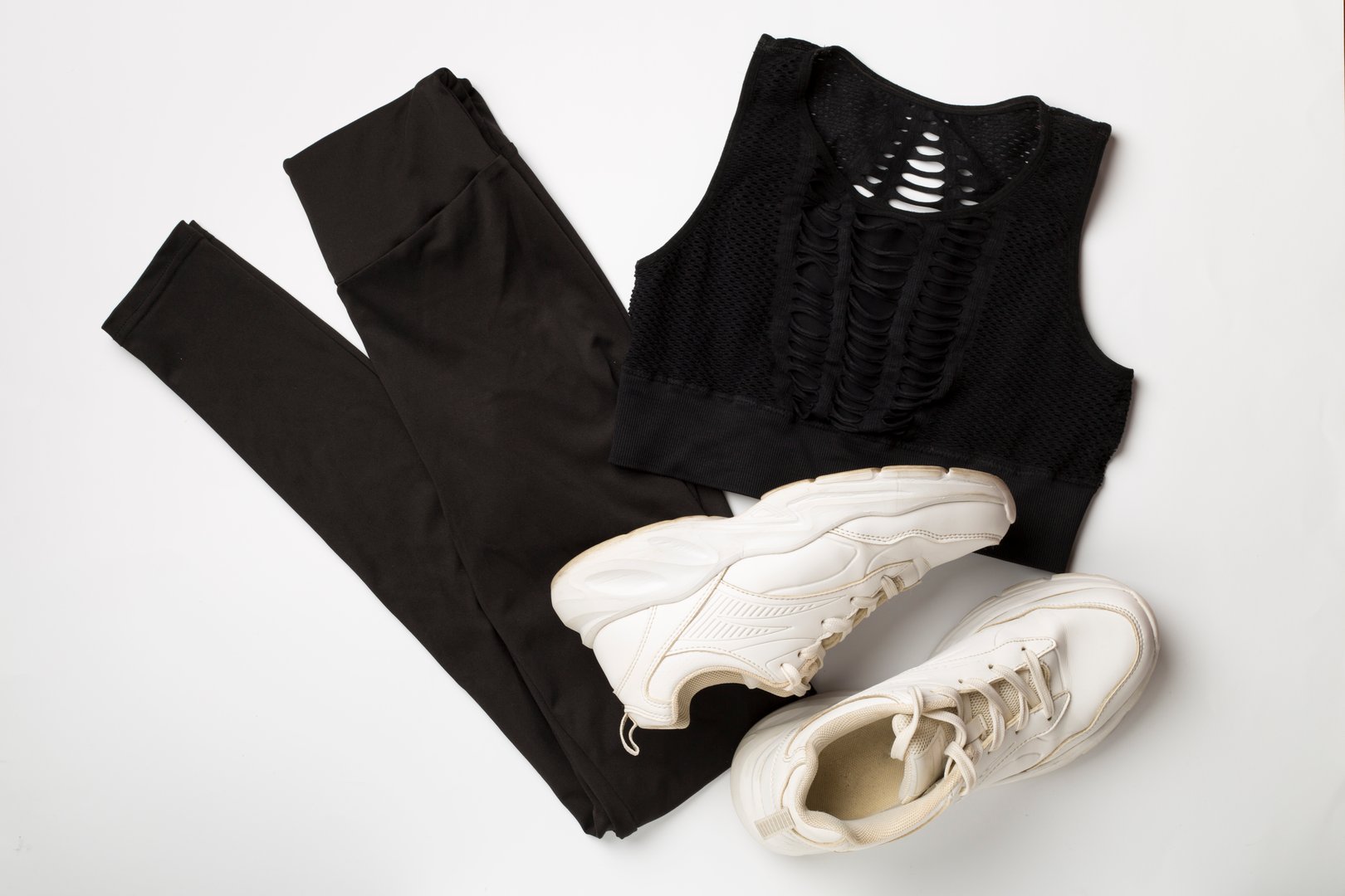 Flat lay composition with sport clothes on white background, top view.