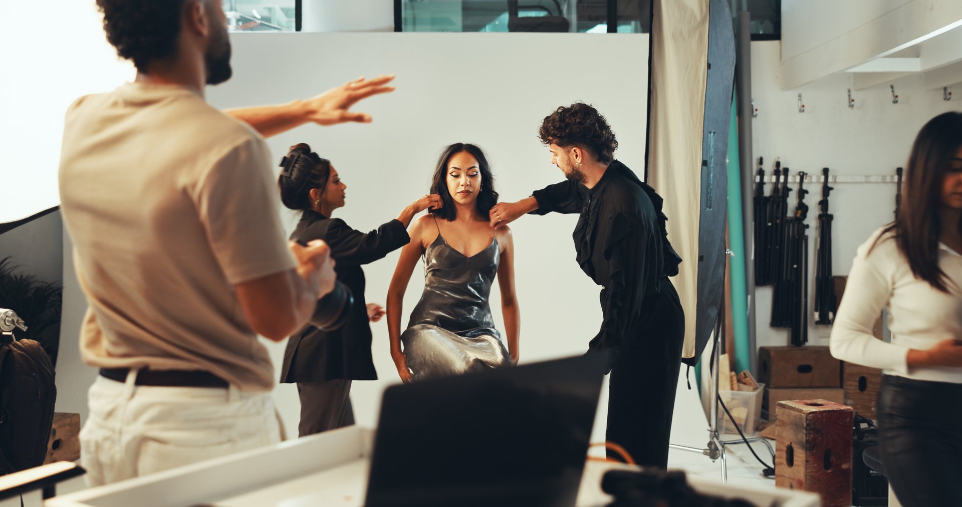 People, beauty and model with makeup or photographer, blog production and teamwork. Studio, group and staff shooting behind the scenes for fashion photography, magazine catalog and filming process