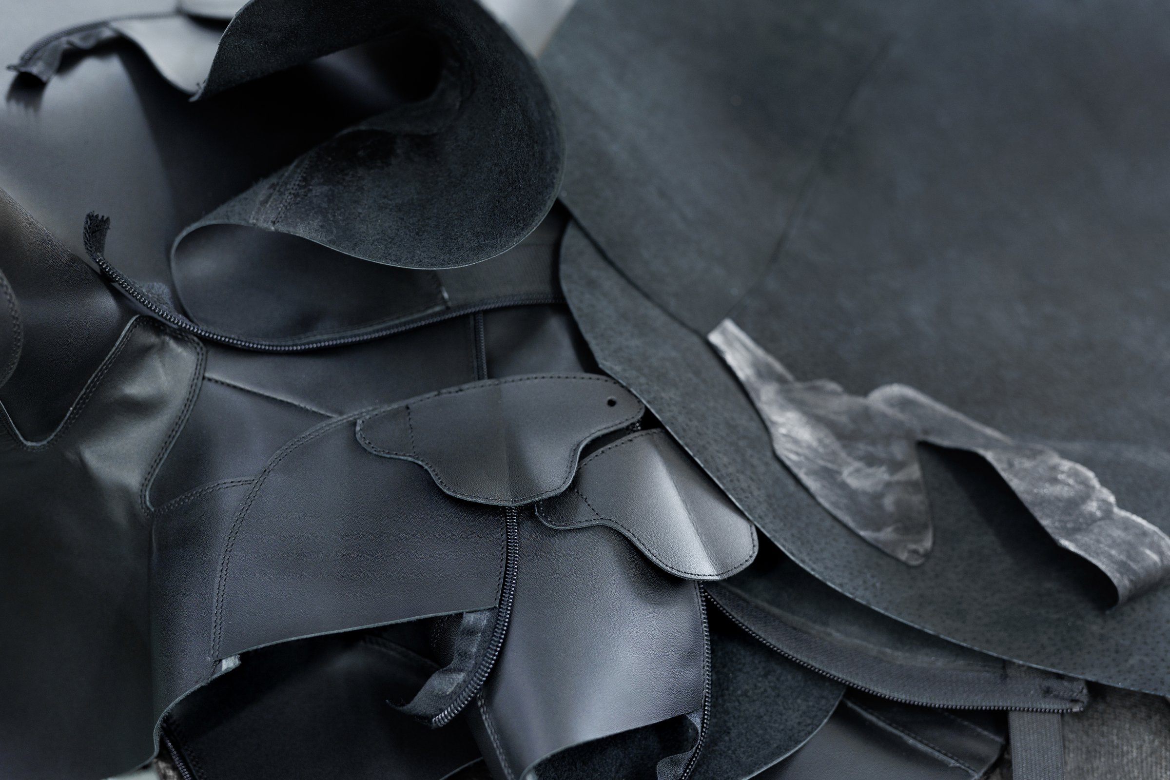 Pieces of leather are lying on the table. Blanks for the manufacture of shoes