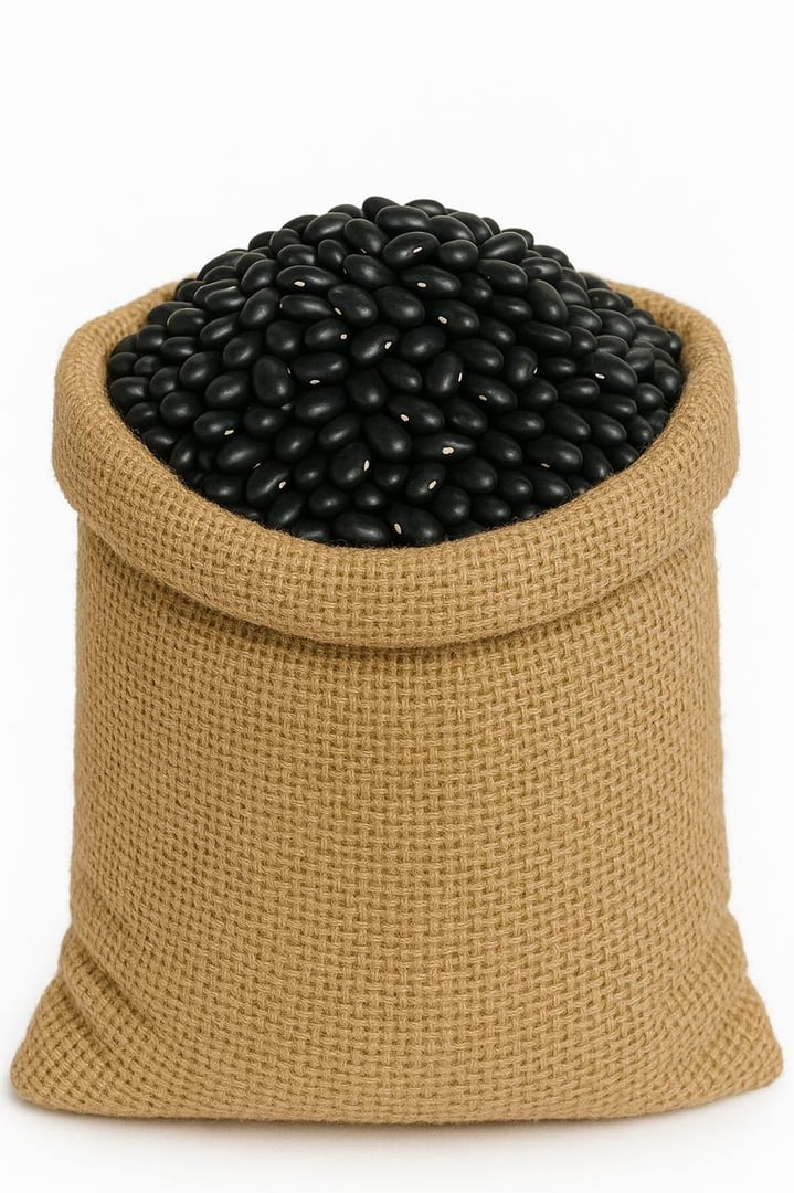 A burlap sack filled to the brim with shiny black beans against a plain white background.