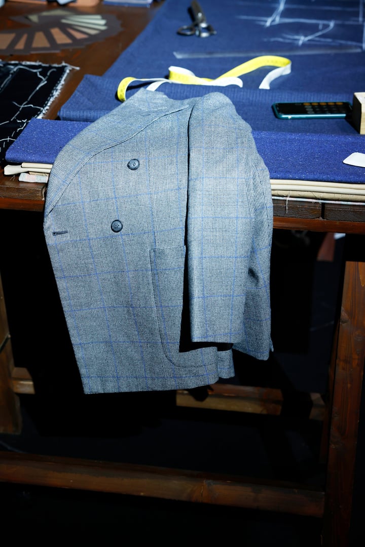 A blue finished tailored coat in the sewing table