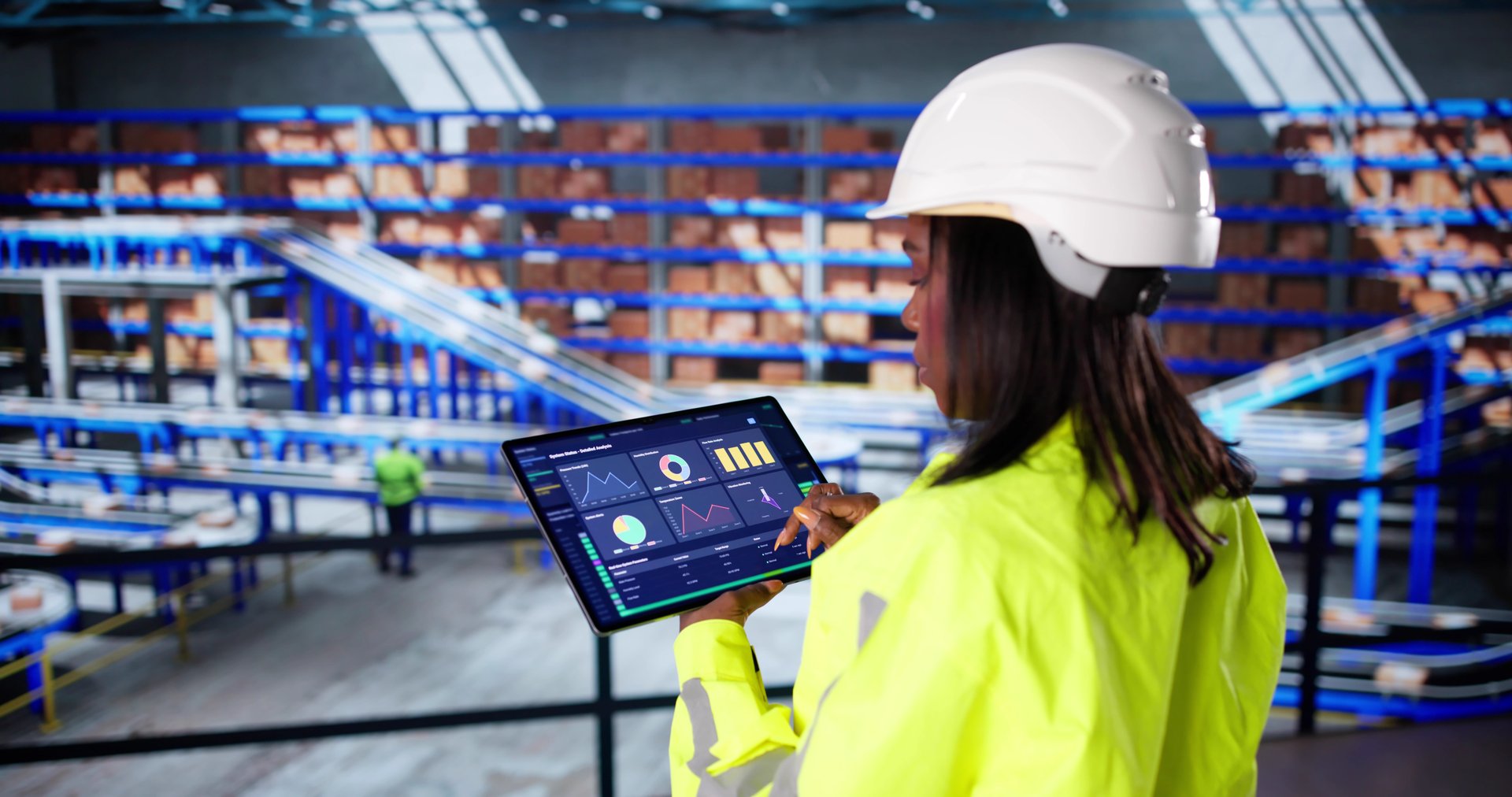 Female Logistic Technician Ensures Safety With Warehouse Automation Software Dashboard