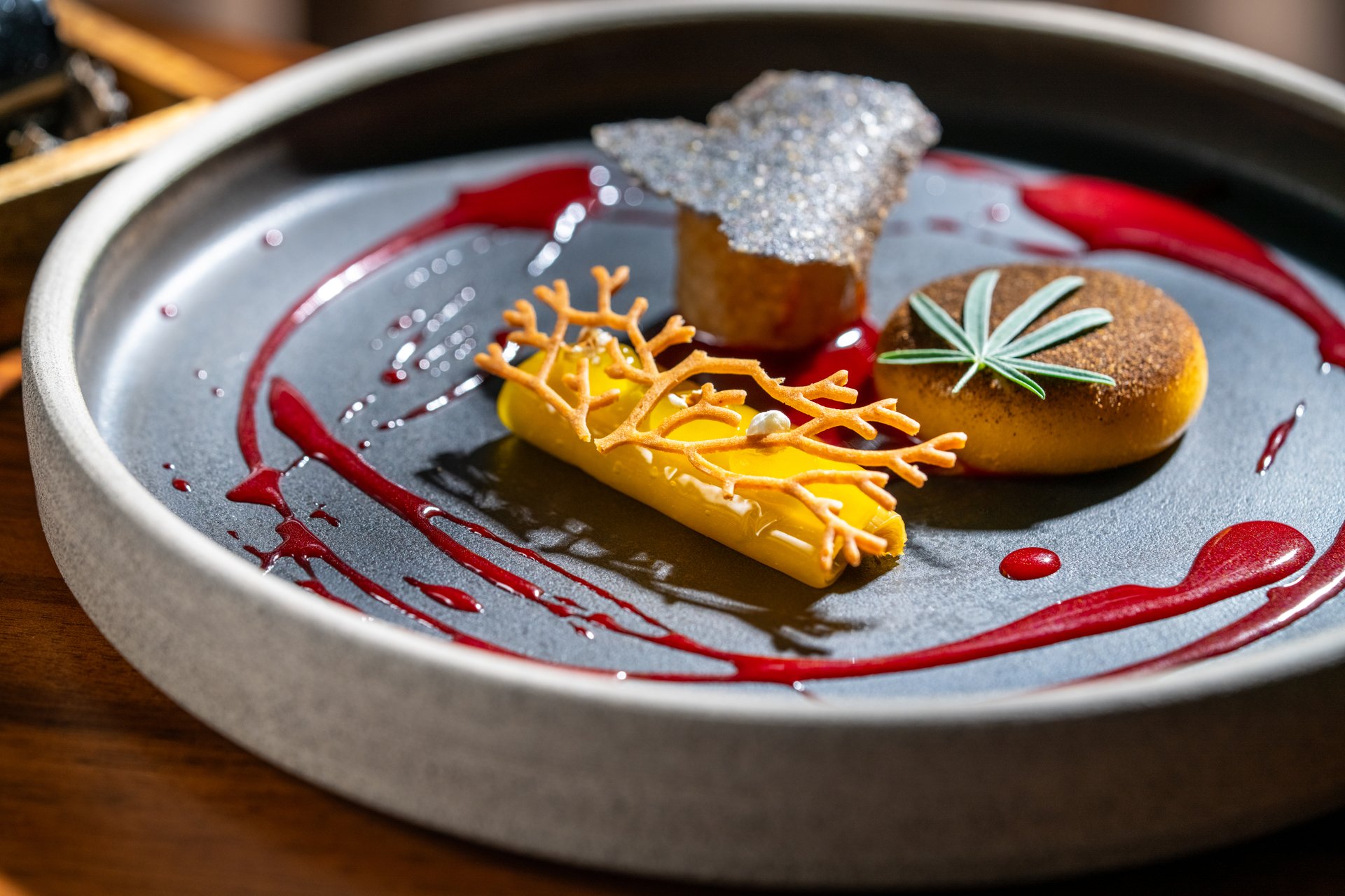 Gourmet dessert dish showcasing molecular gastronomy techniques and artistic culinary plating