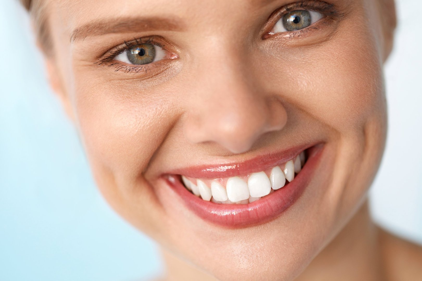 Beautiful Smile. Closeup Portrait Of Beautiful Happy Young Woman With Perfect White Teeth, Fresh Beauty Face And Healthy Soft Skin Smiling. Woman's Health, Skin Care Concept. High Resolution Image