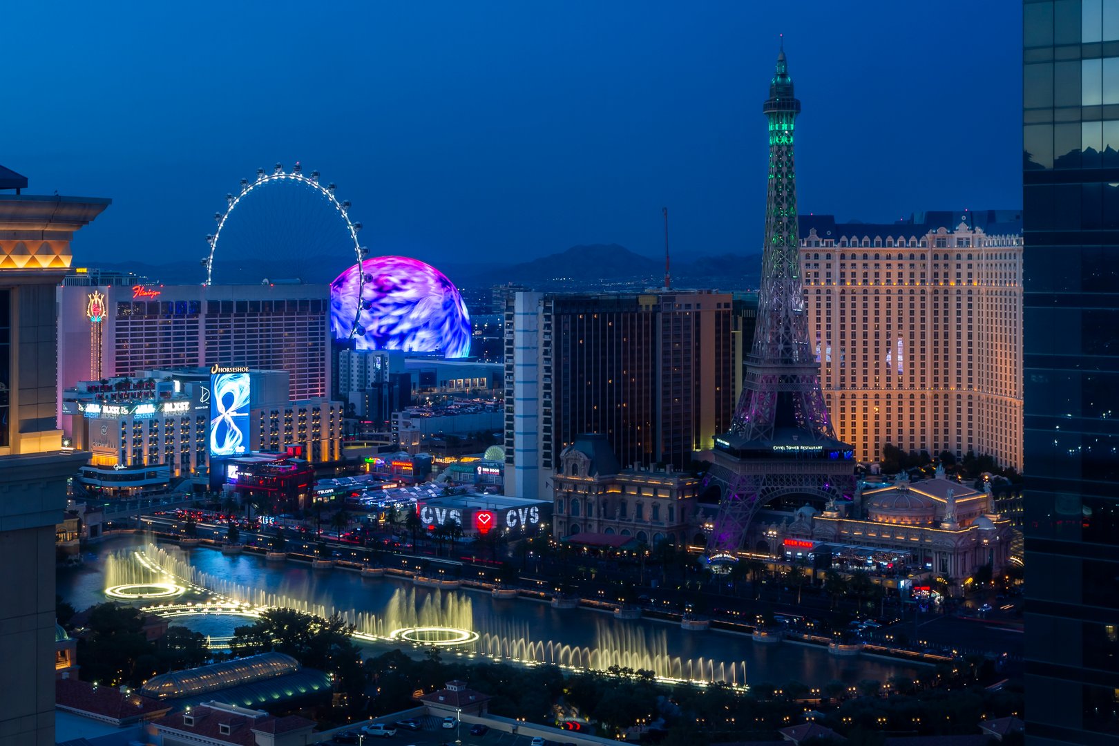 Las Vegas, NV, USA - June 16th, 2024: Beautiful view of The Strip, The Sphere and full replica of the Eiffel Tower in twilight