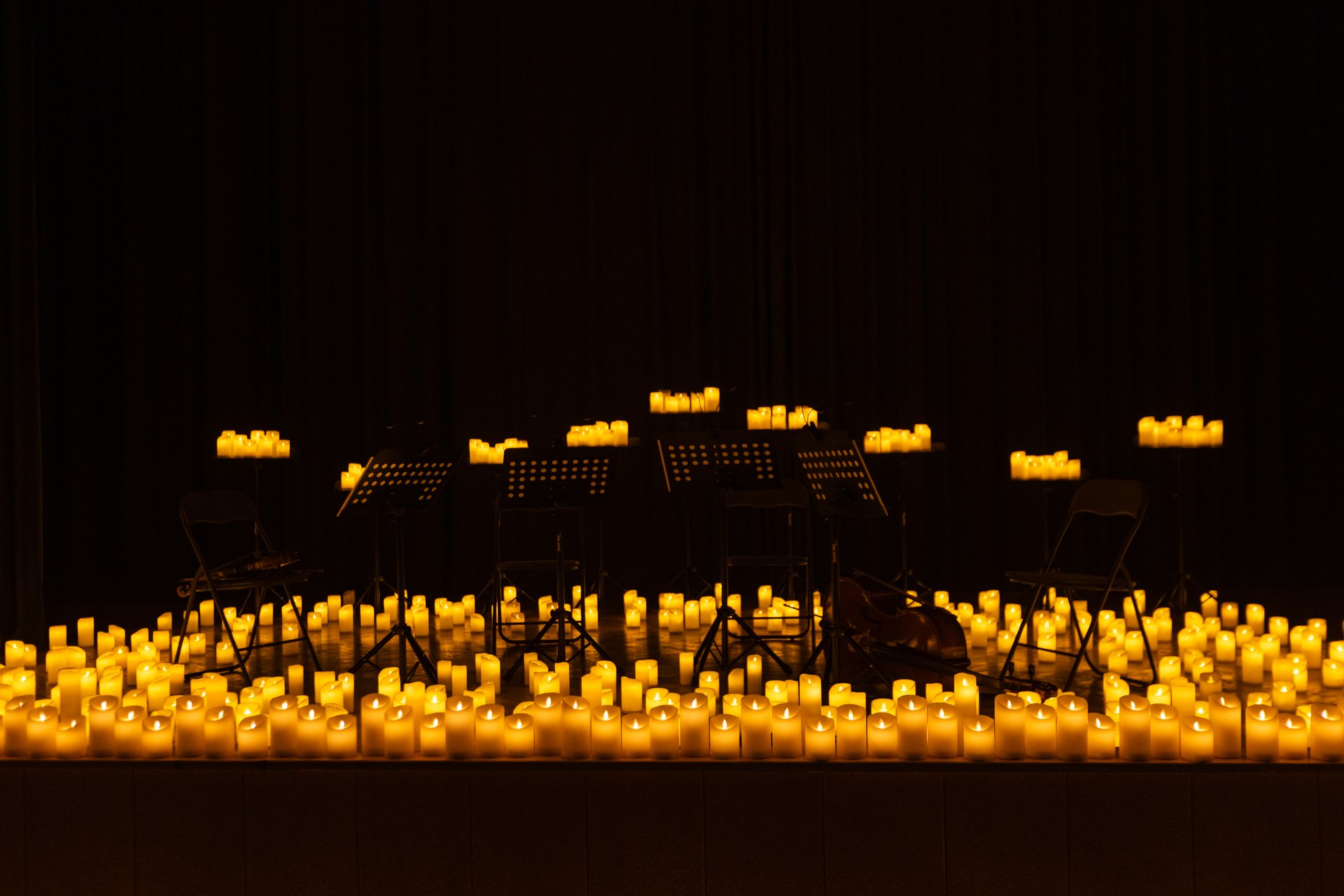 blurred symphonic orchestra on stage with lots of candles for design purpose