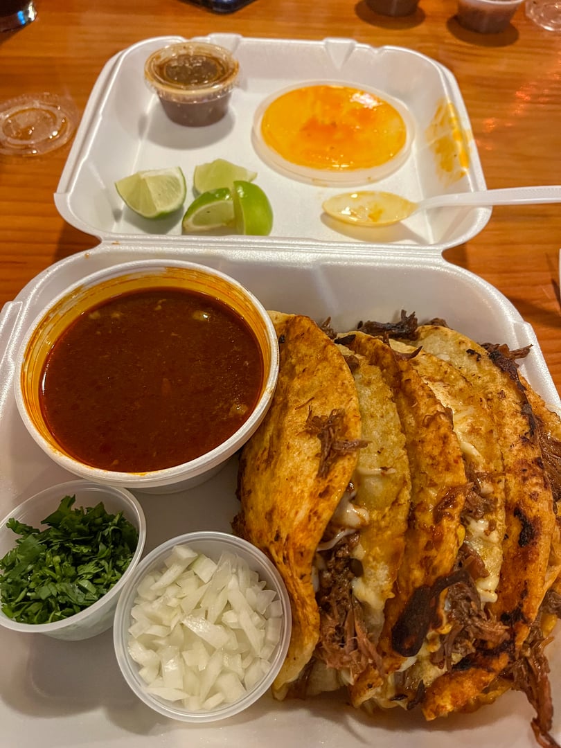 Beef quesabirria tacos from a food truck with consommé.