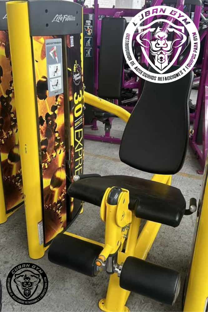 Yellow exercise machine with black seat and branding for Cuban Gym. Equipment in a fitness facility setting.