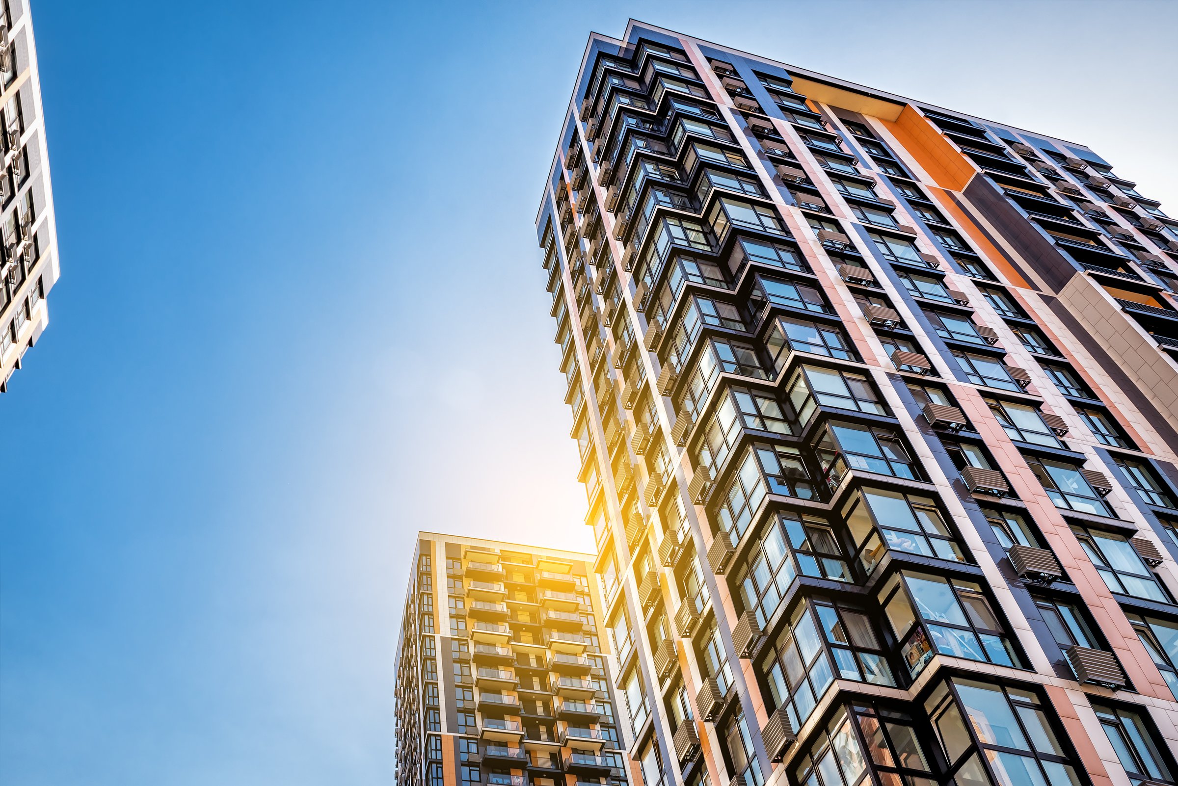 Modern tower buildings or skyscrapers under blue sky at beautiful sunset