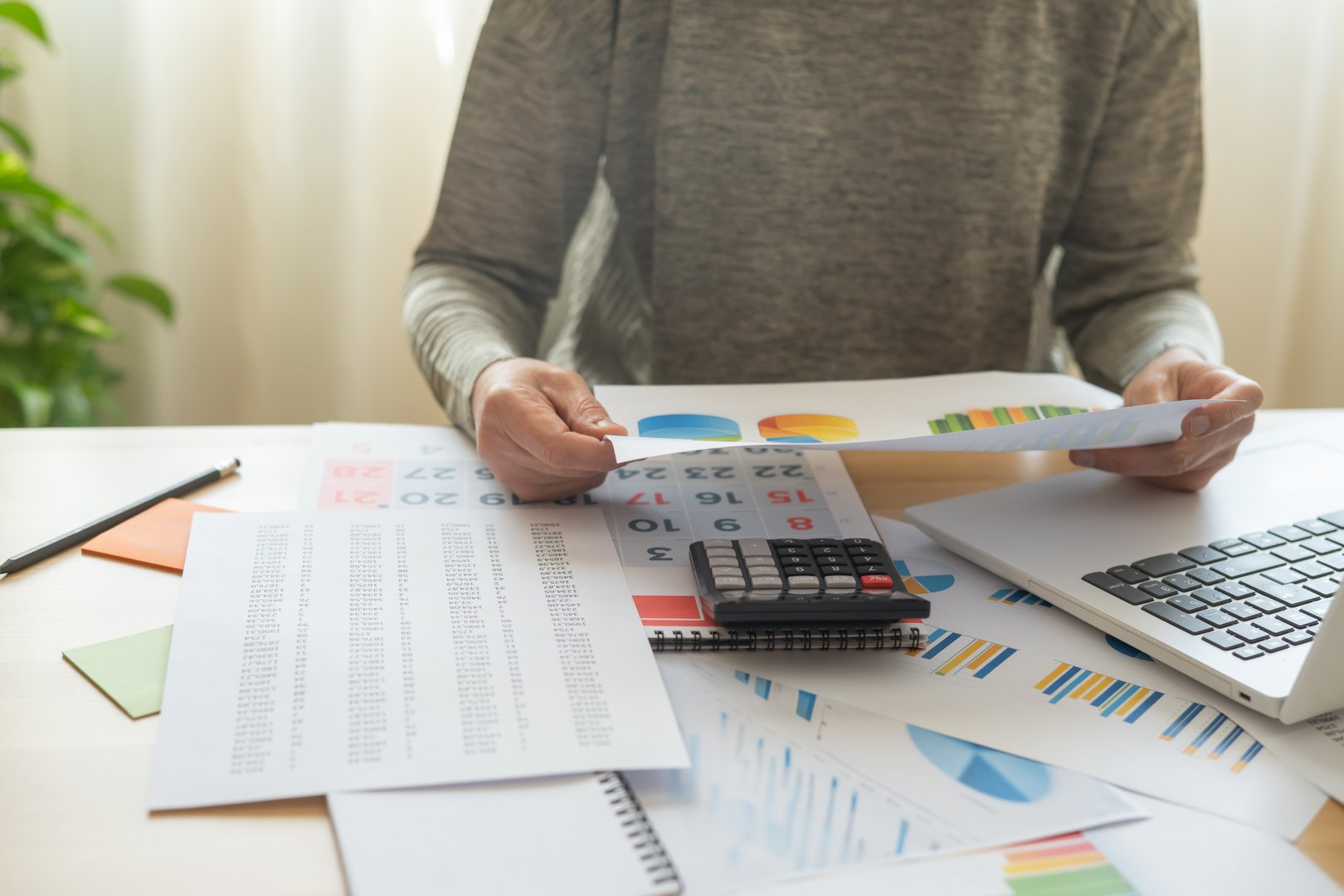 Accountant Working On Financial Reports And Stock Market Analysis For Business Success, Featuring Marketing Strategies And Professional Tools In Office Or Home Workspaces.