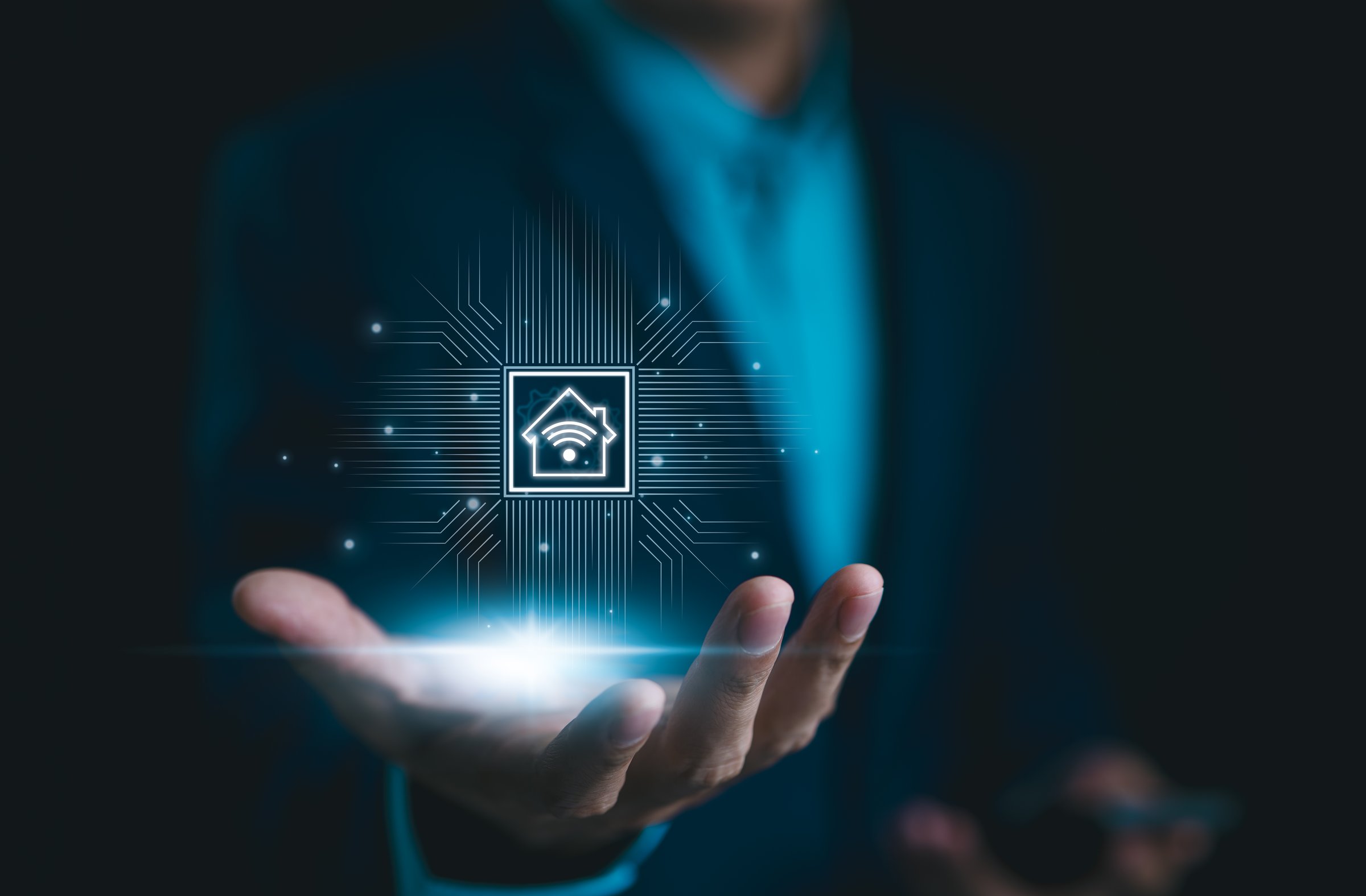 Smart Home Technology, IoT Integration Concept. Businessman presents smart home technology icon in his hand, representing IoT integration. Future of connected living, home automation. Remote control,