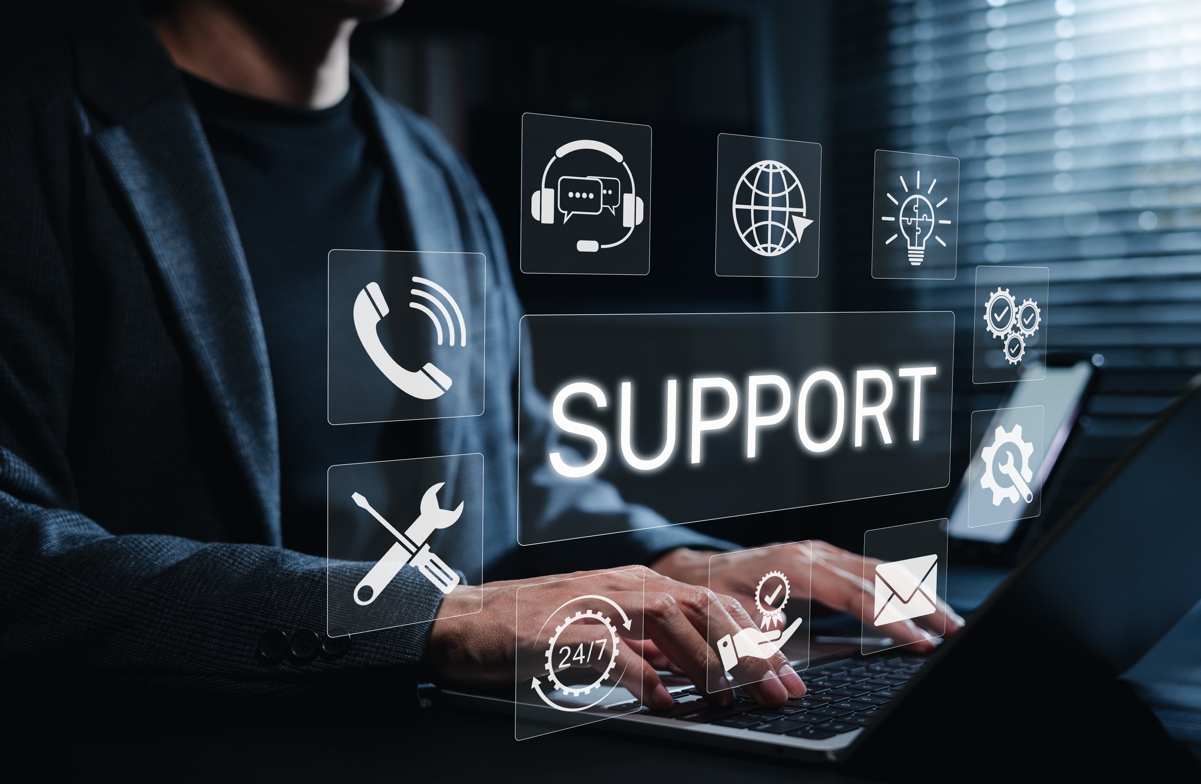 Technical Support and Customer Service Concept. Person using laptop with icons for phone, chat, email, tools, and 24/7 service, representing technical support, IT helpdesk, customer service assistance