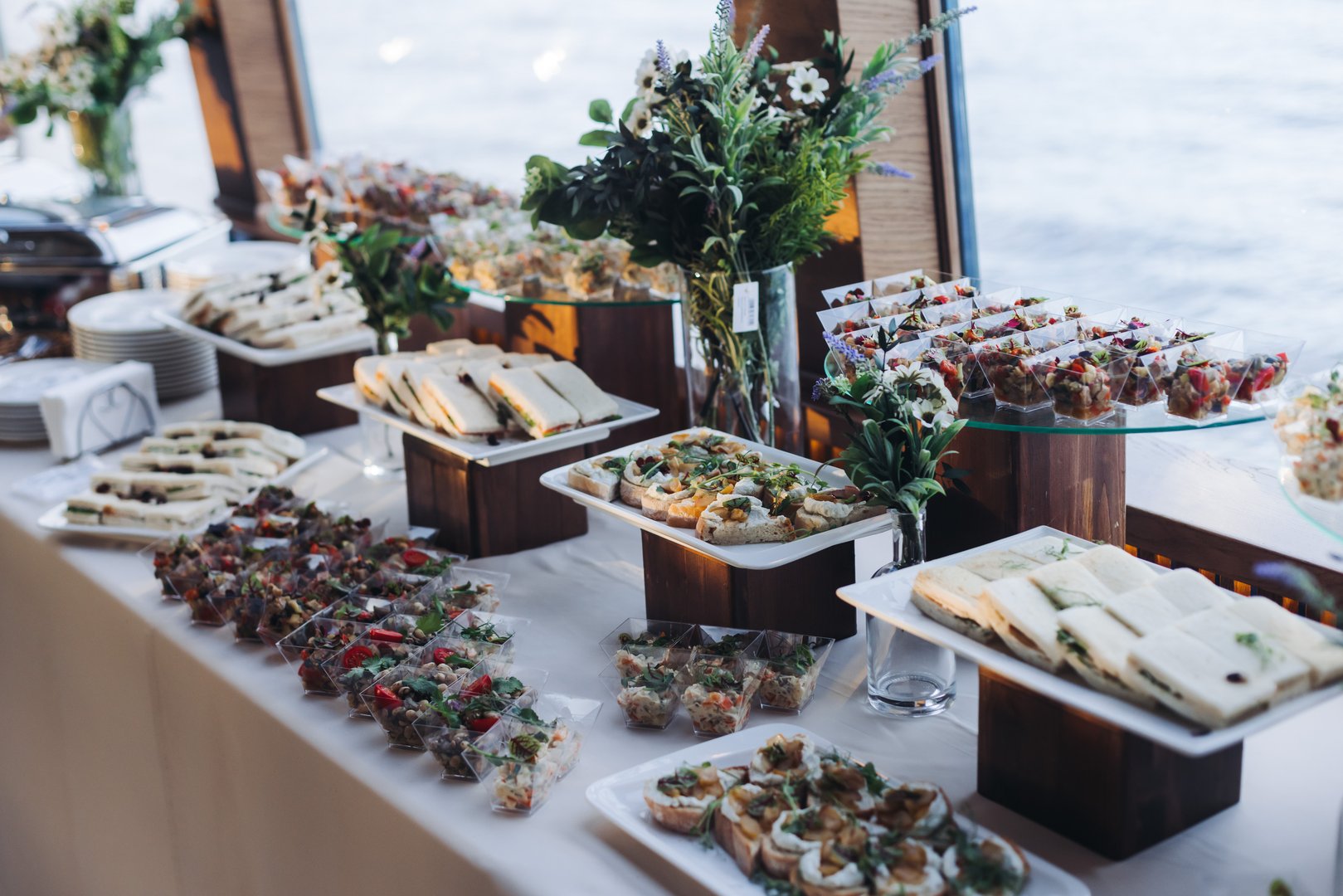 Catering table, beautifully decorated banquet with variety different food snacks appetizers on christmas corporate birthday party event or wedding celebration, canape, salad, delicatessen setting