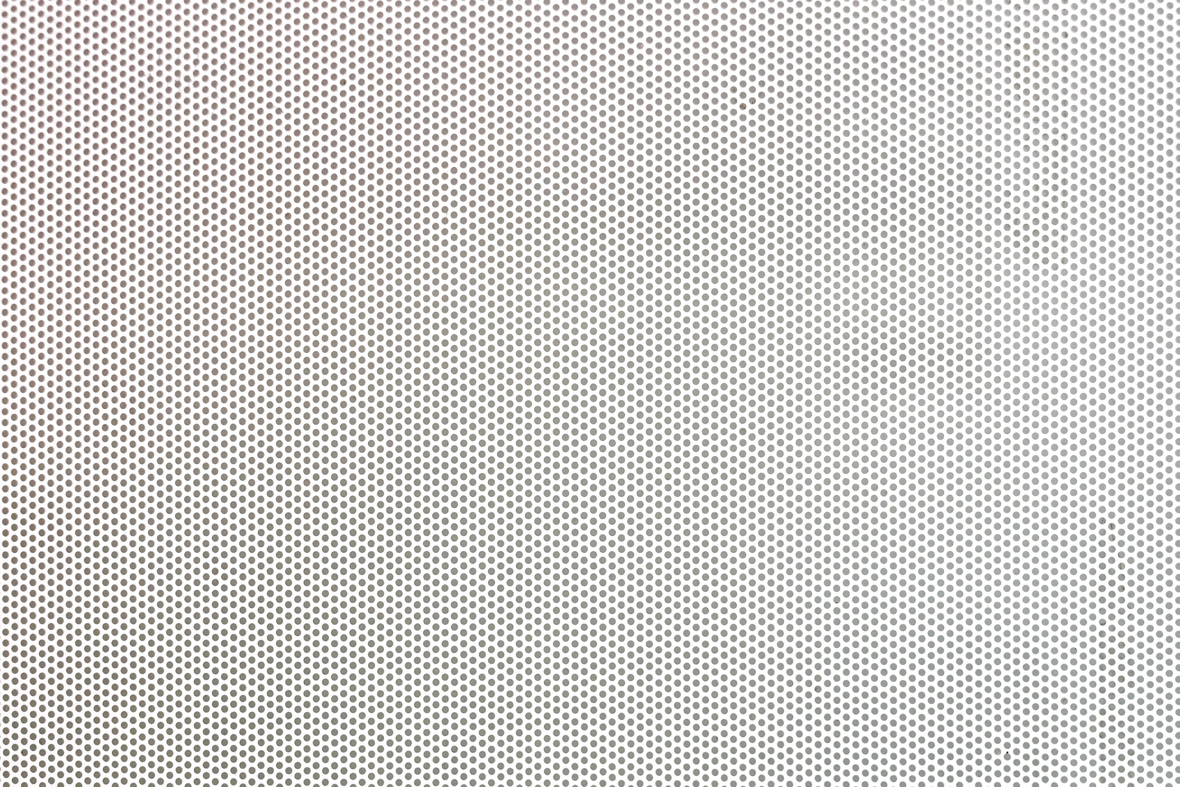 White metal plate with many small holes.