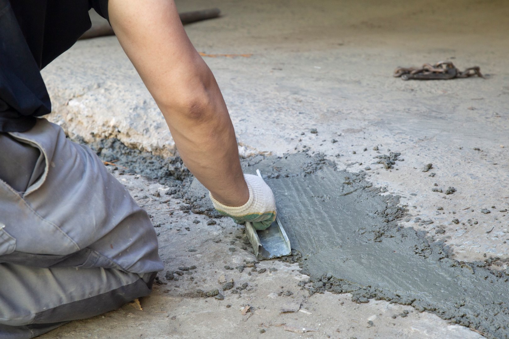 Installing ceramic tiles on the floor in an office space.