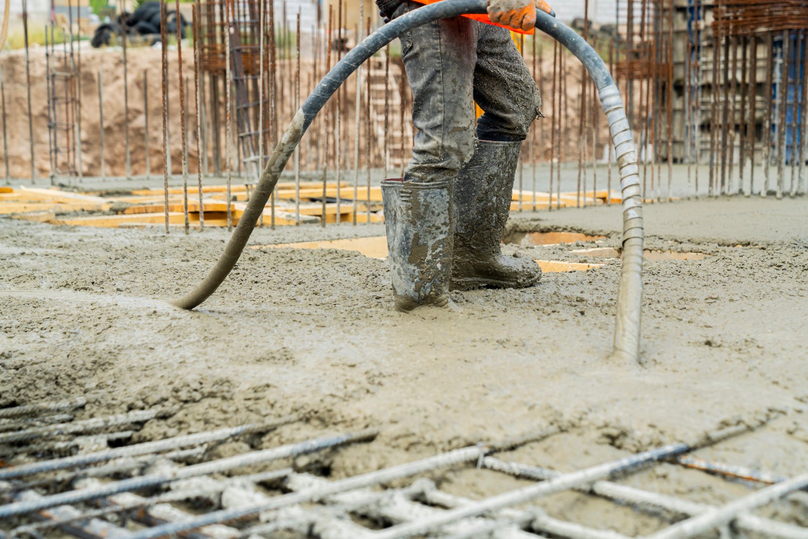 Construction worker Concrete pouring during commercial concreting floors of buildings in construction site and Civil Engineer, Concrete construction and reinforcement