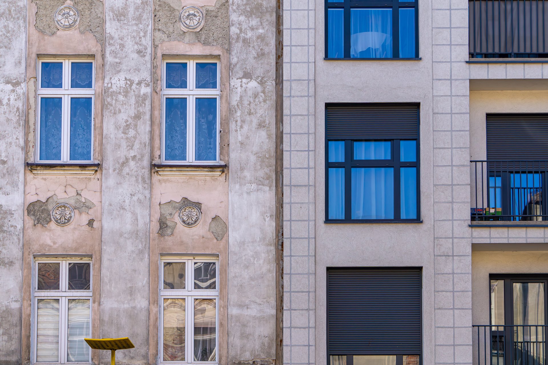 connection of two tenement houses new and old. tenement house after renovation versus before. renovation of the building.