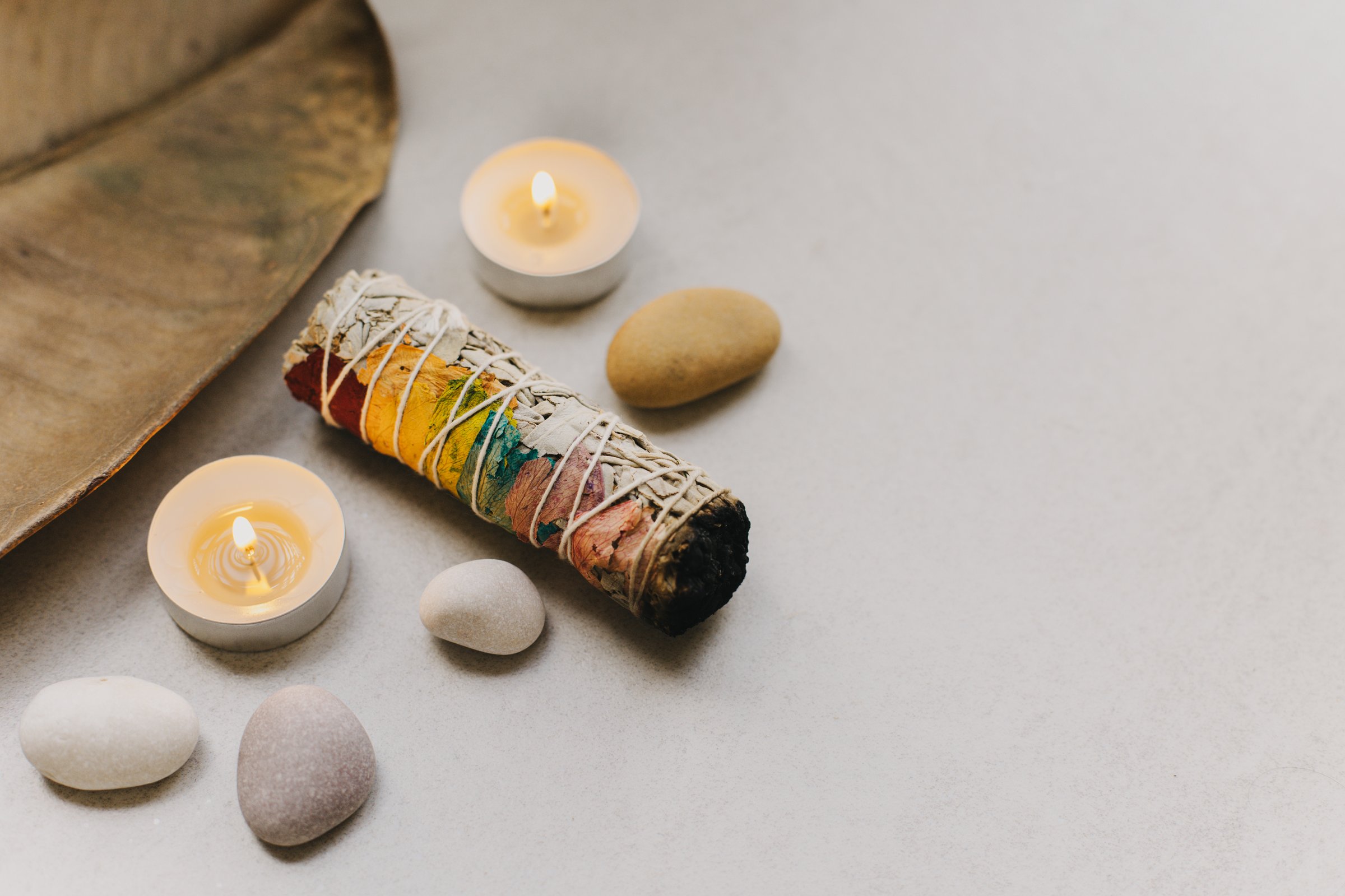 White sage and candle with stones for meditation. Minimalism. Calm and mindfulness. Place for text.