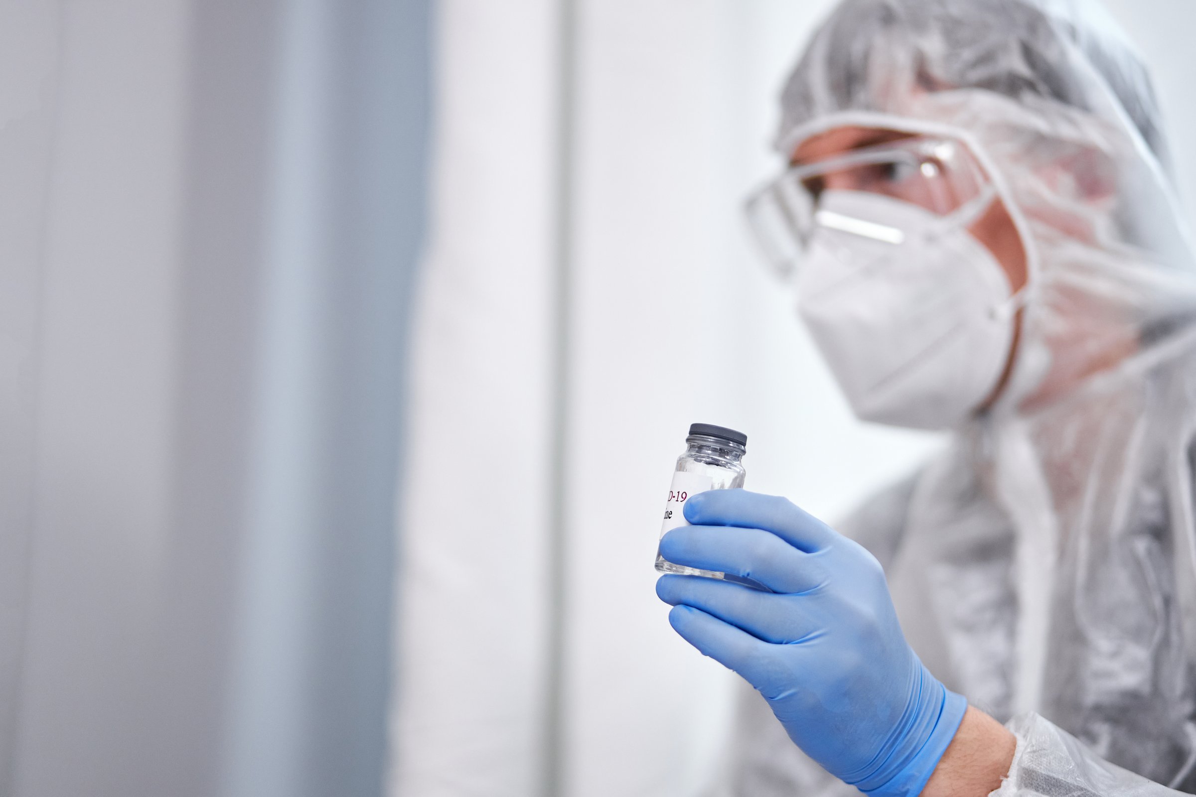 syringe injection and vaccine in male doctor hand, preparing to vaccine patient at home, sit talking, giving consultation. use for prevention, immunization and treatment from corona virus infection