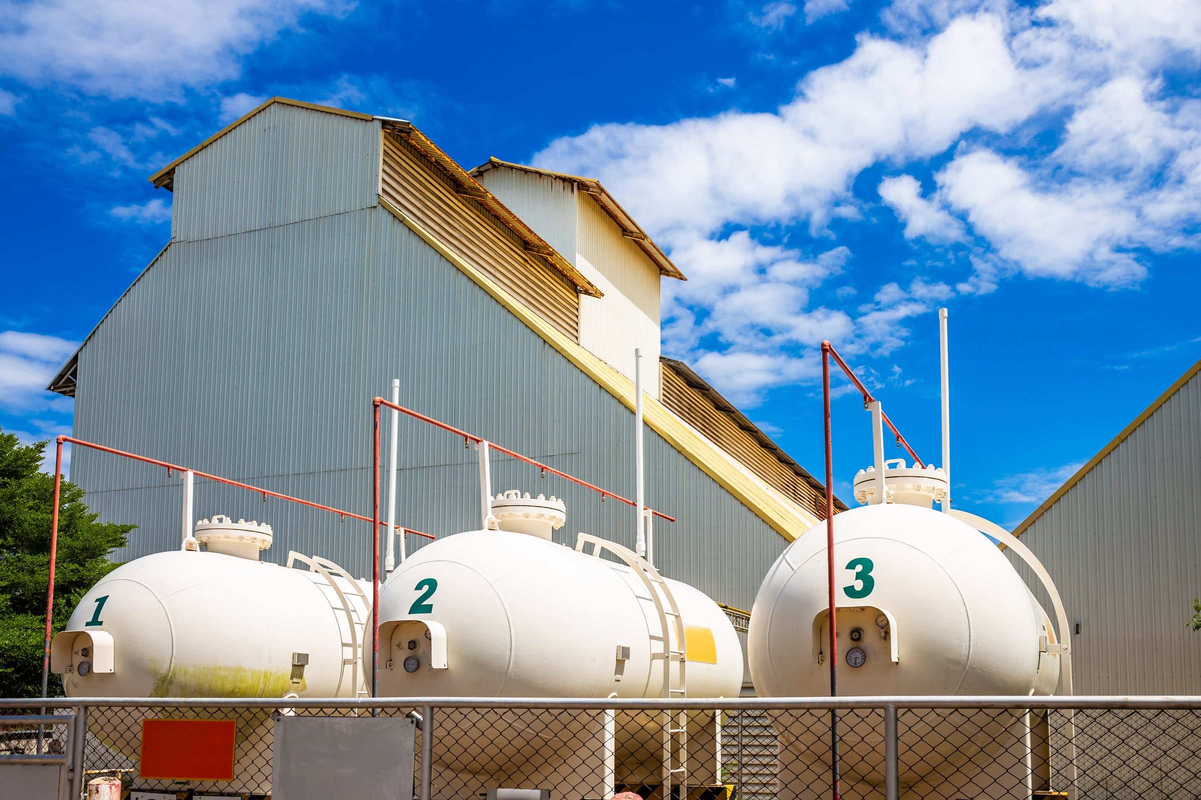 Large gas tanks are used in industrial plants for production.