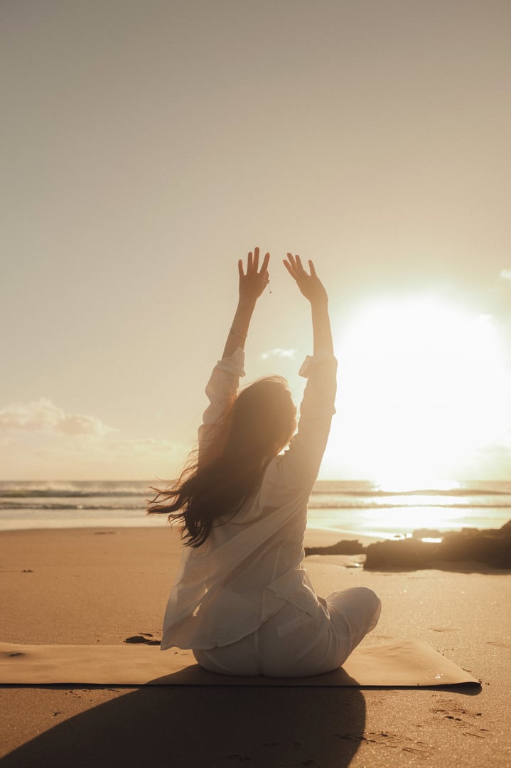 Asian woman in white clothes practice yoga for meditation and relaxation for healthy near seaside. Healthcare exercise and yoga concept. Solo tourism. Part of a series.