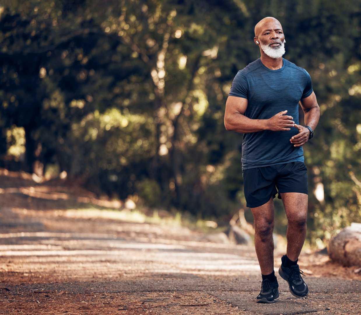 Run, black man outdoor and fitness for health, thinking and training for balance, target and healthy lifestyle. African male, mature guy and athlete in forest, nature and concentration with exercise