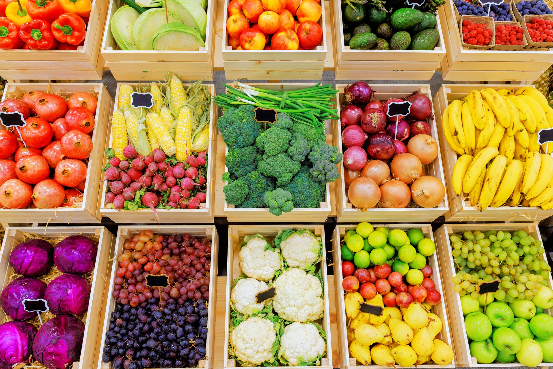 Baskets filled with various fruits, vegetables showcase vibrant colors fresh produce in bustling farmer market.