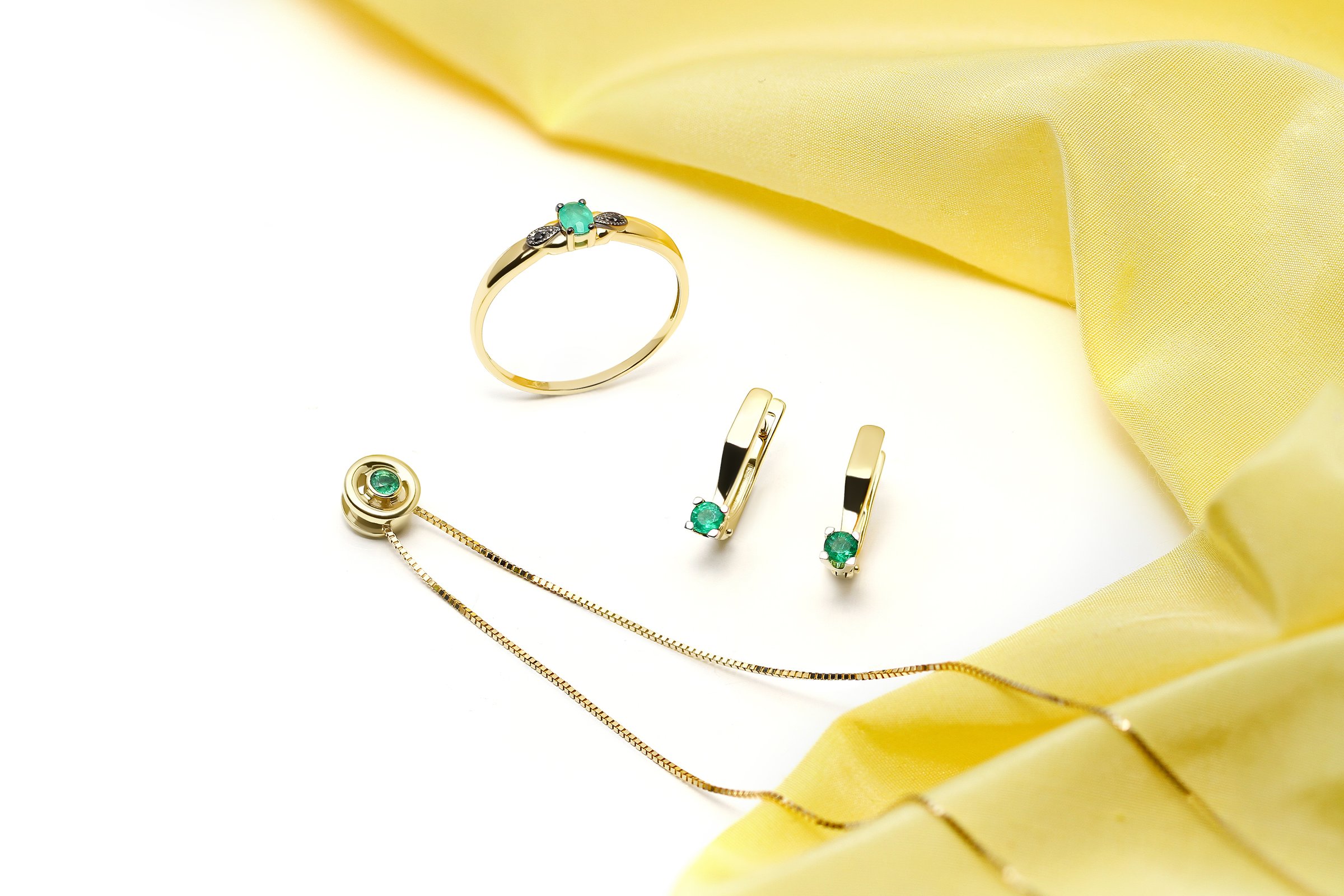 Elegant jewelry set. Jewellery set with gemstones. Jewelry accessories collage. Product still life concept. Ring, necklace and earrings.