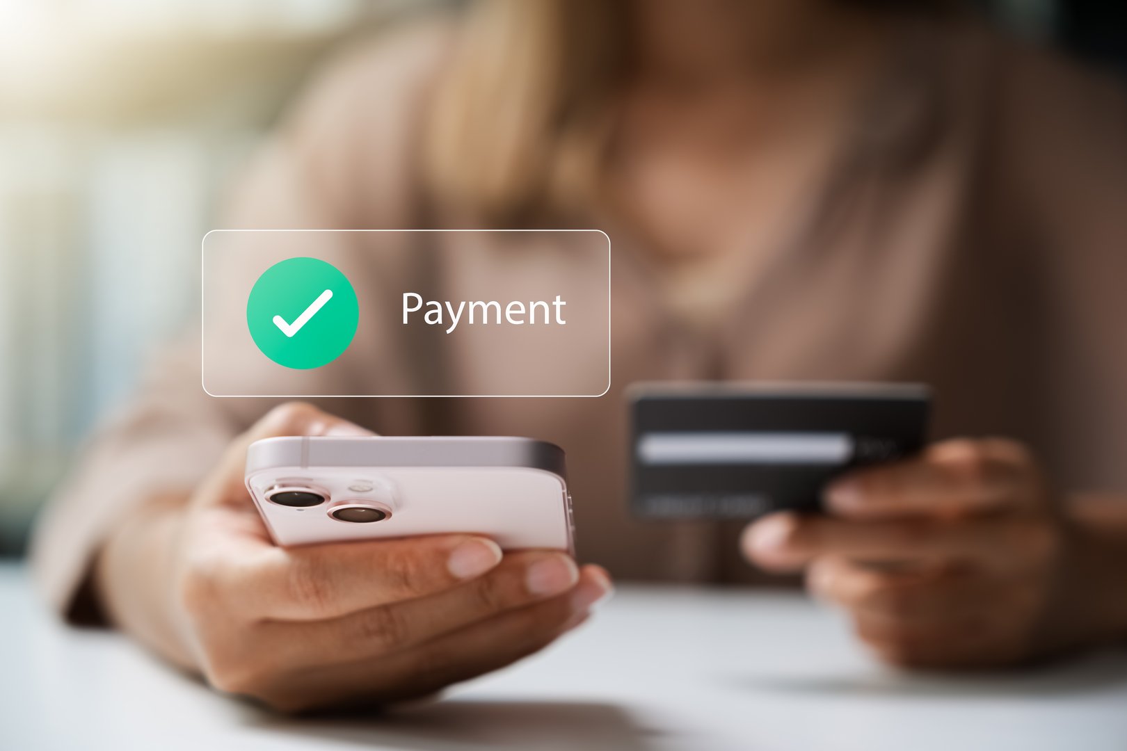 Female customer utilizes smartphone for online payments via credit or debit cards, e-wallets, and mobile payment methods.