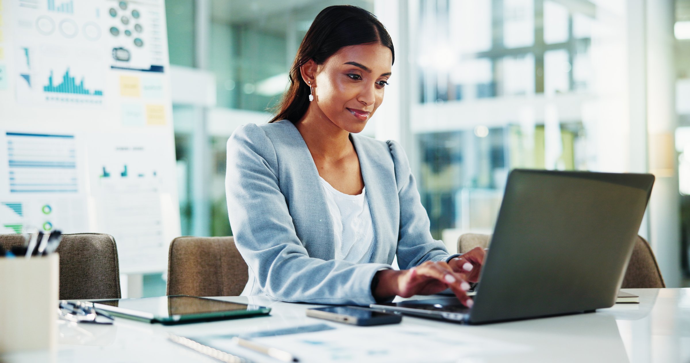 Finance, businesswoman and typing on laptop at desk for tax compliance report, risk management and auditing review. Reading, accountant and technology for financial proposal and investment project