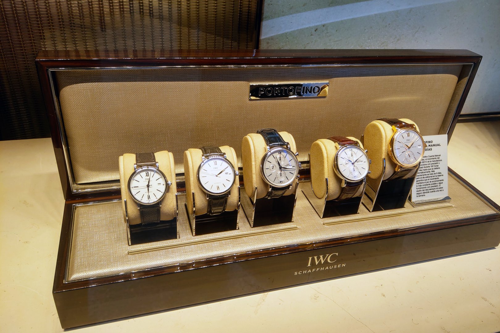 Girona, Spain, October 3, 2024: Showcase of five iwc portofino watches elegantly displayed in a retail case. crafted with precision and style, each timepiece features distinct designs, luxury watchmaking artistry from iwc schaffhausen.