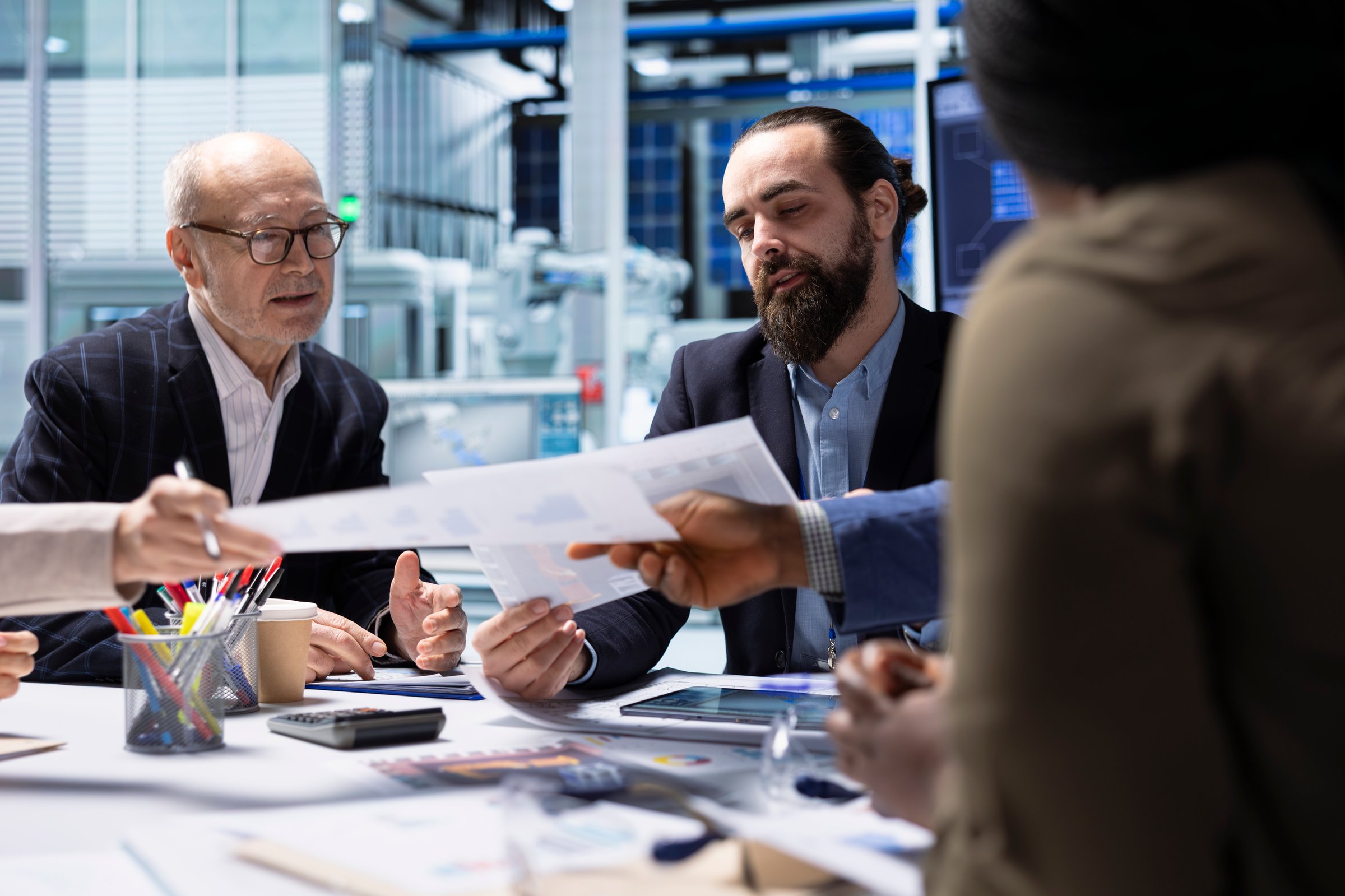 Industrial plant executive holding paperwork documents to presents business strategies to investors. Manager outlining key opportunities for growth to shareholders using documentation files