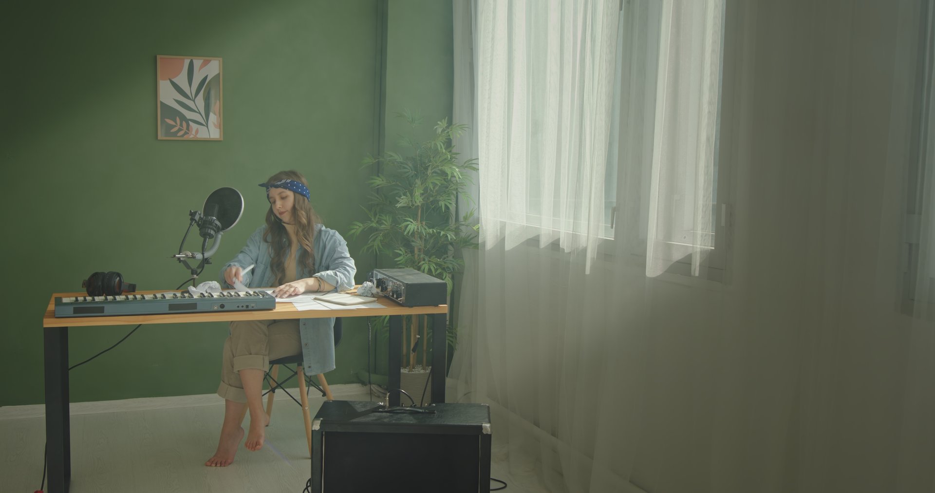 A tranquil and serene home studio setup showcasing a focused individual deeply engaged in the music creation process