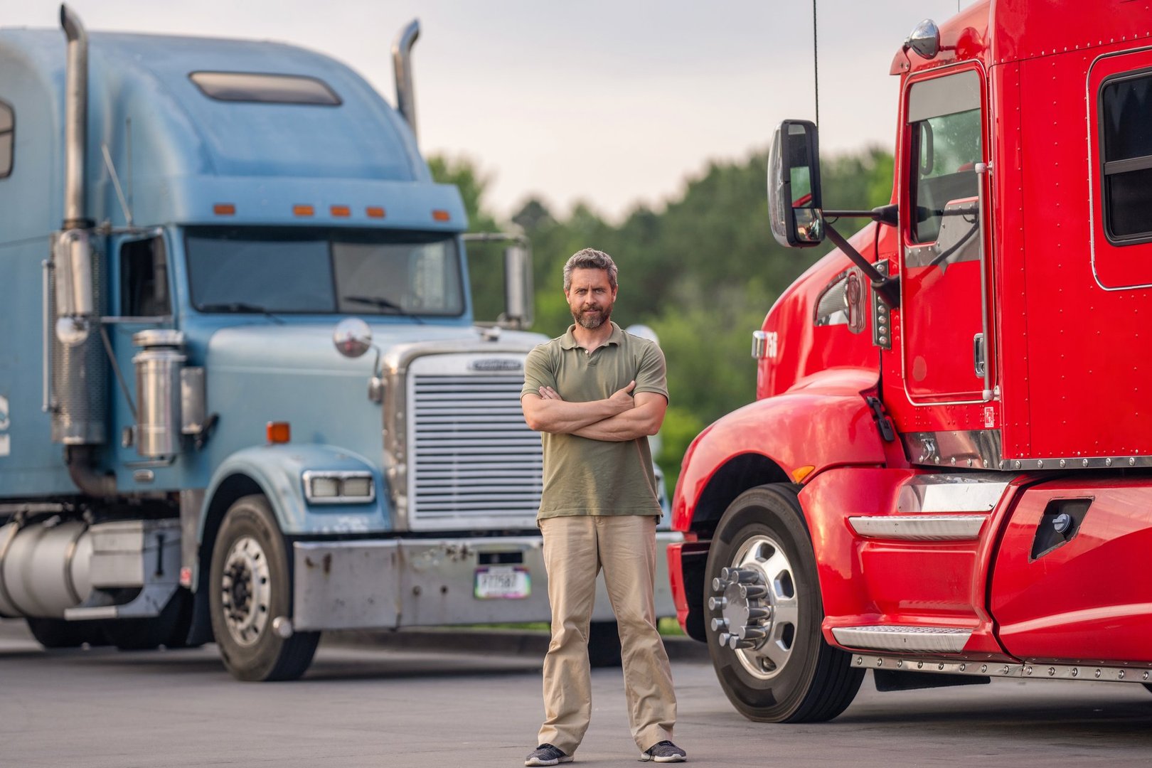 Truck driver. Trucking owner. Transportation vehicles. Hispanic man in front of truck. Semi trucks vehicle. Man owner truck driver. Transportation industry. Man driver near lorry. Big rig semi truck.
