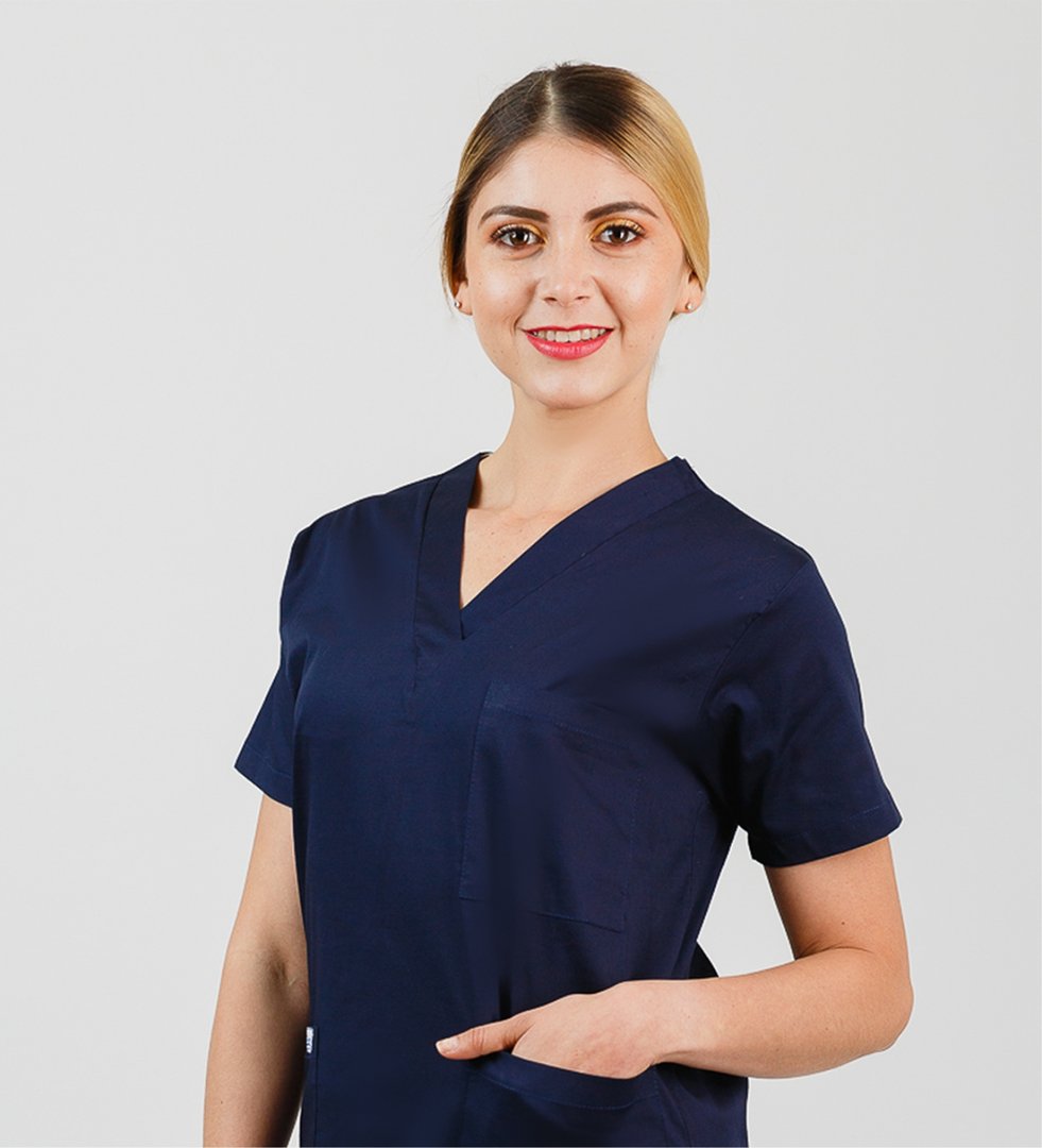 Man in a blue polo shirt smiling against a plain white background.