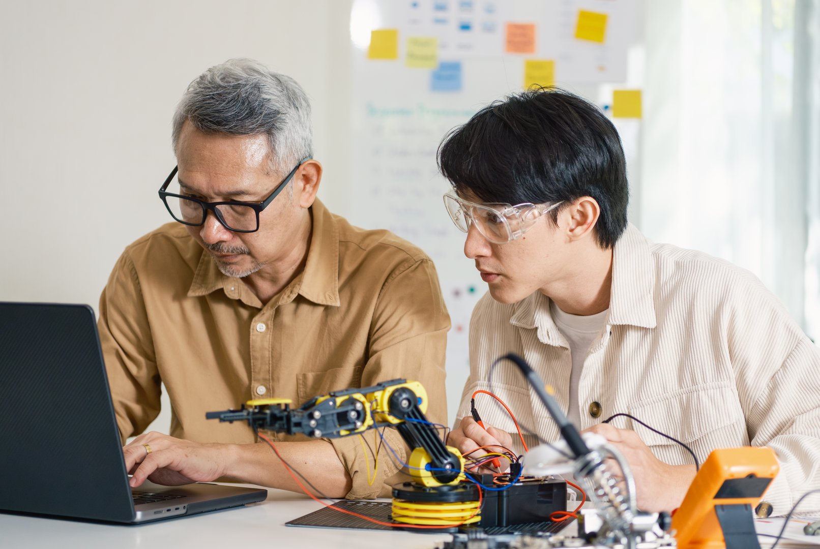 engineering robot technology with asian programmer innovation and research teamwork in coding development