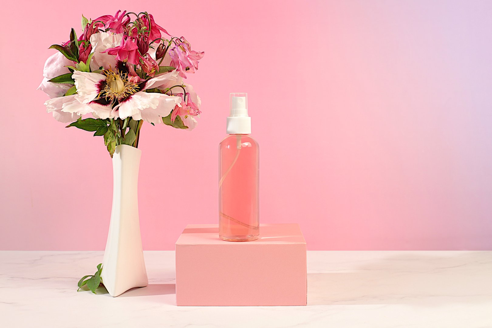 Wellness composition with rose water, fresh flowers of mountain peony and columbine, spa salon advertising card, natural self-care and healthy lifestyle concept, abstract composition with flowers