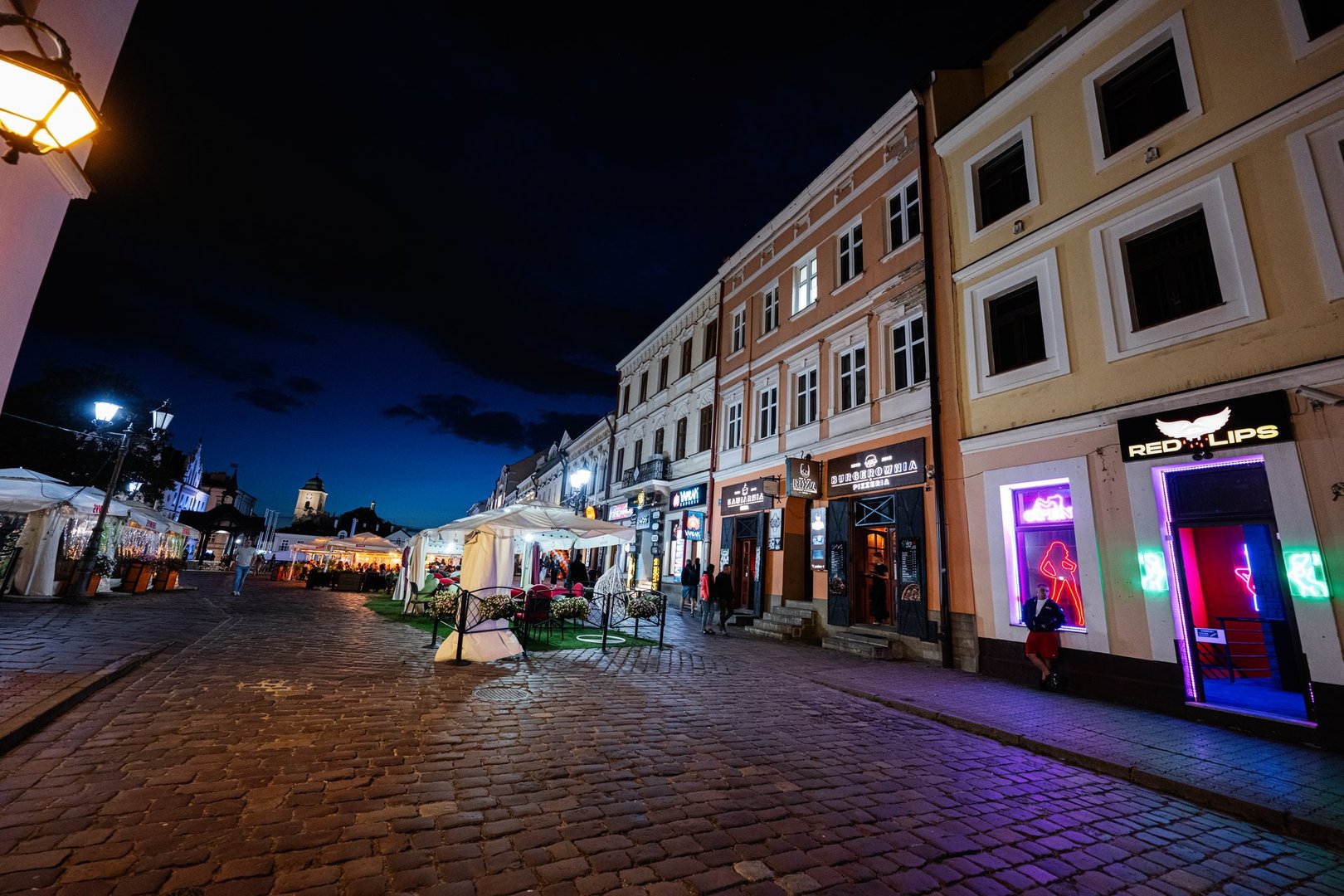 Rzeszow, Poland - August 22, 2025: Nighttime view of Rzeszow, Poland with vibrant streets and illuminated buildings.