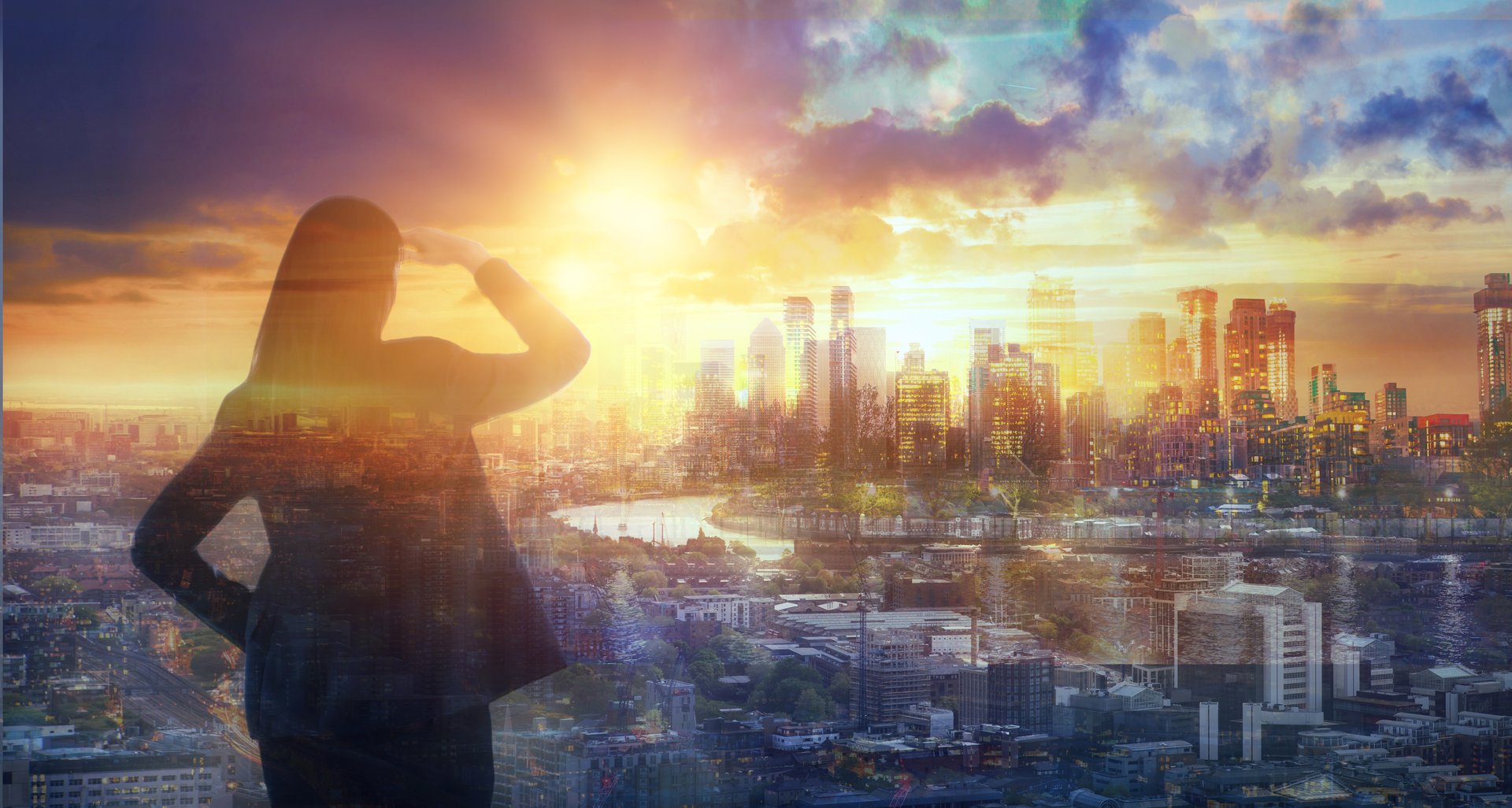 Young woman looking over the City of London at sun set. Future, new business opportunity and business success concept.