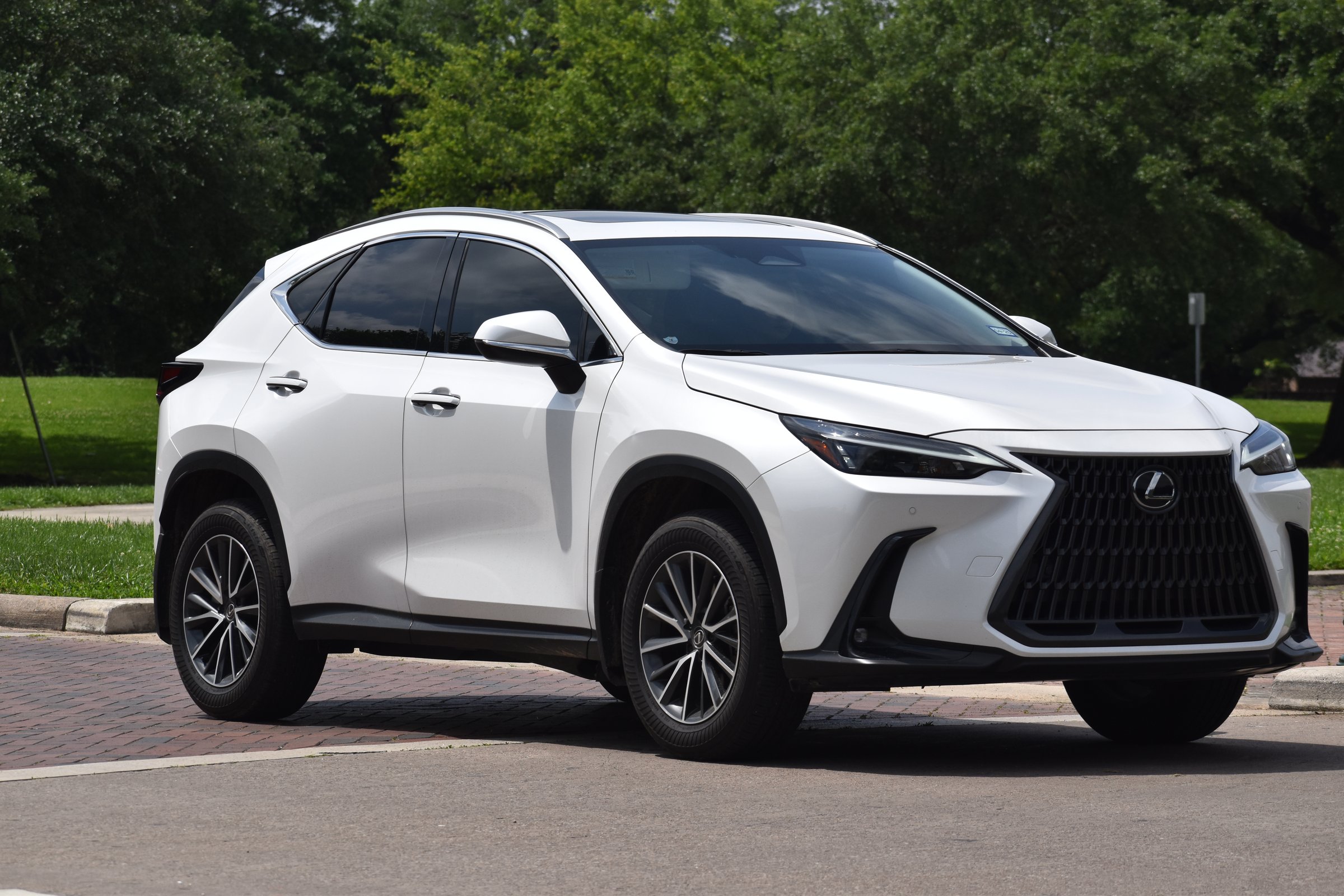 Houston, TX USA 4-29-2024 - A white colored Lexus NX SUV cruising near Herman Park in Houston