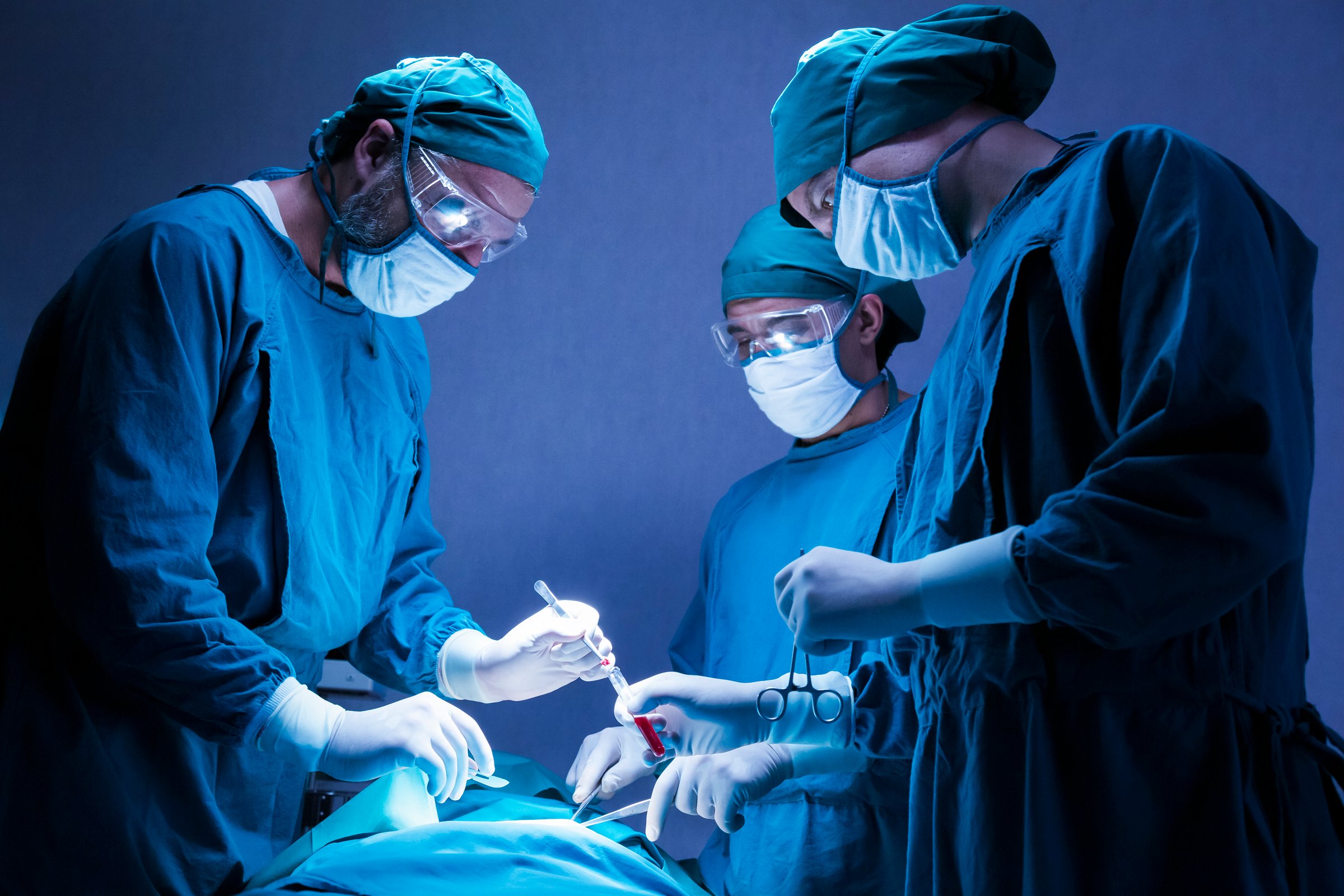 concentrated professional surgical doctor team operating surgery a patient in the operating room at the hospital. healthcare and medical concept.