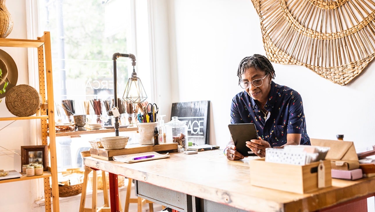Business owner working in shop with tablet