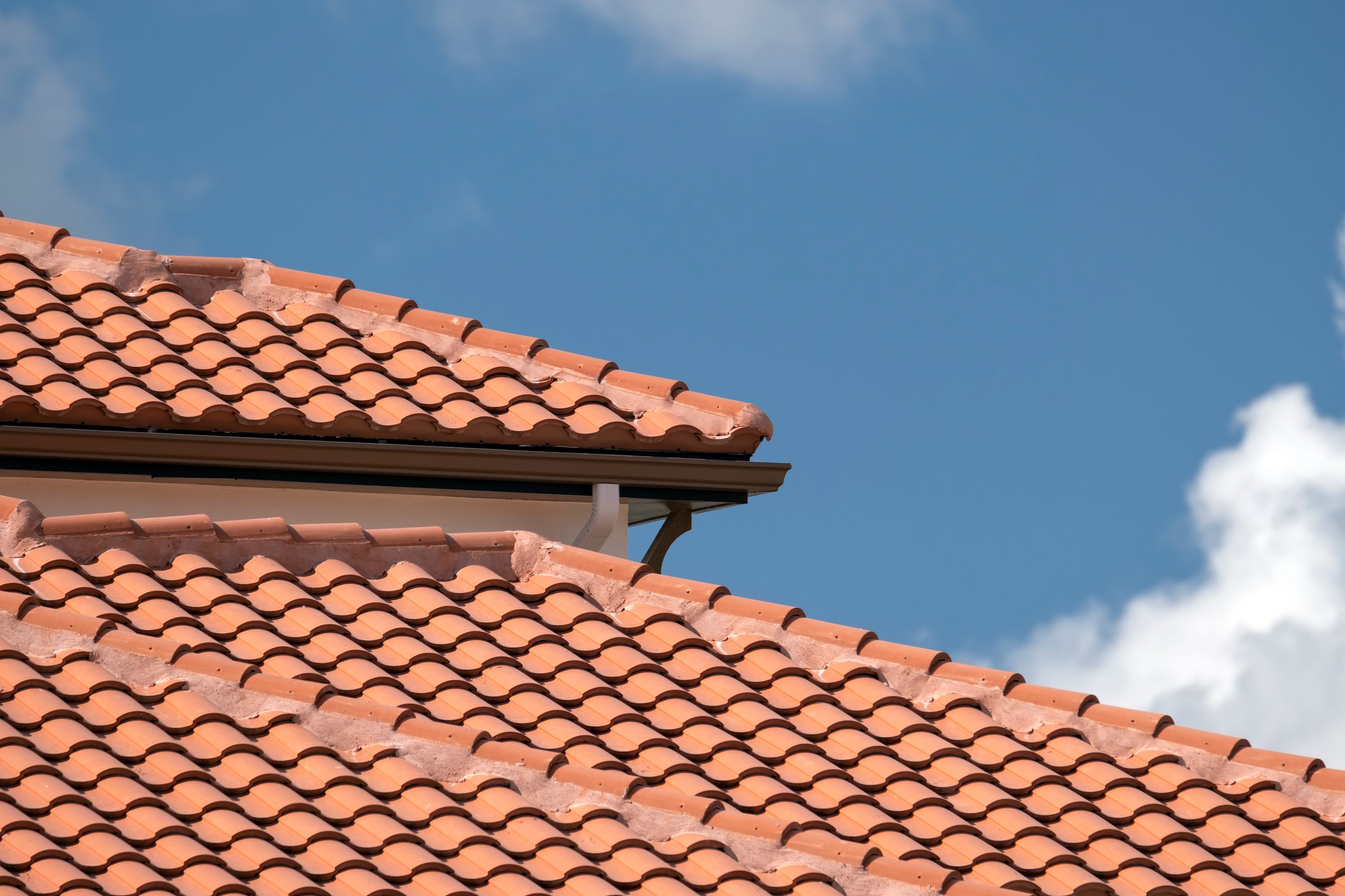 Overlapping rows of yellow ceramic roofing tiles