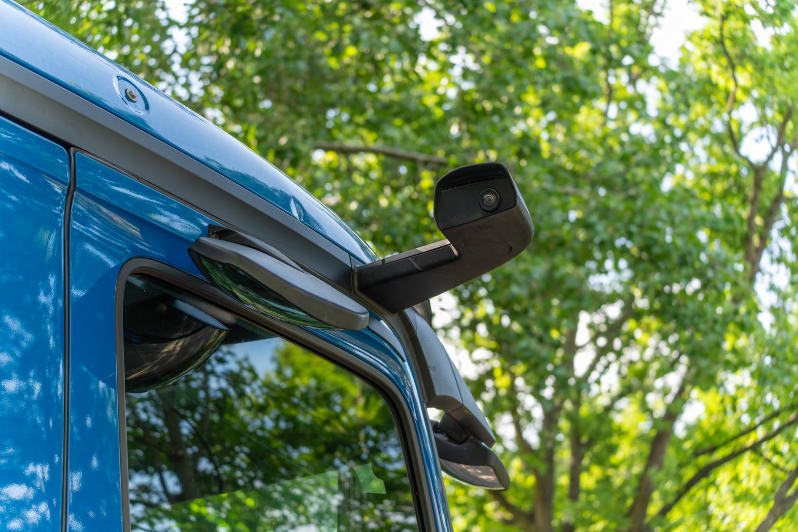 Side-view mirror camera on a modern truck. The camera replaces traditional exterior mirrors for better visibility and safety.