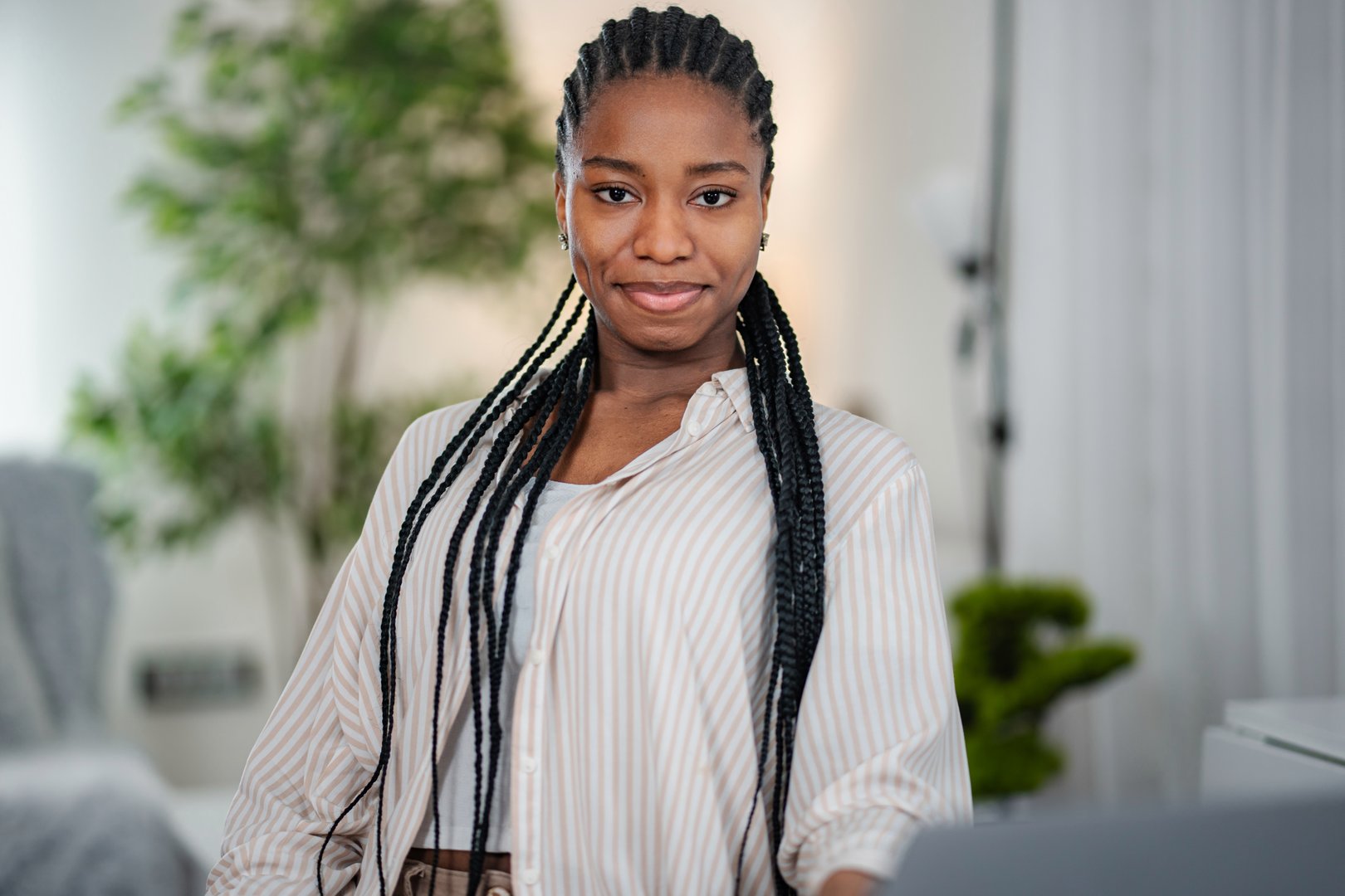 Young adult black woman smiling in office setting